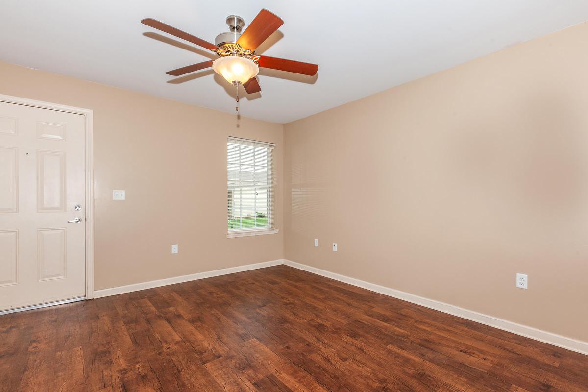 a large empty room with a wood floor