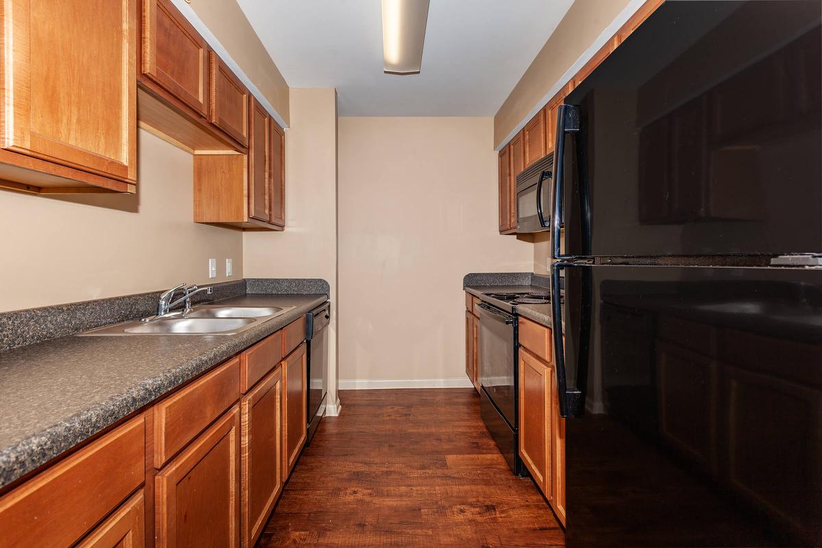 a kitchen with stainless steel appliances and wooden cabinets