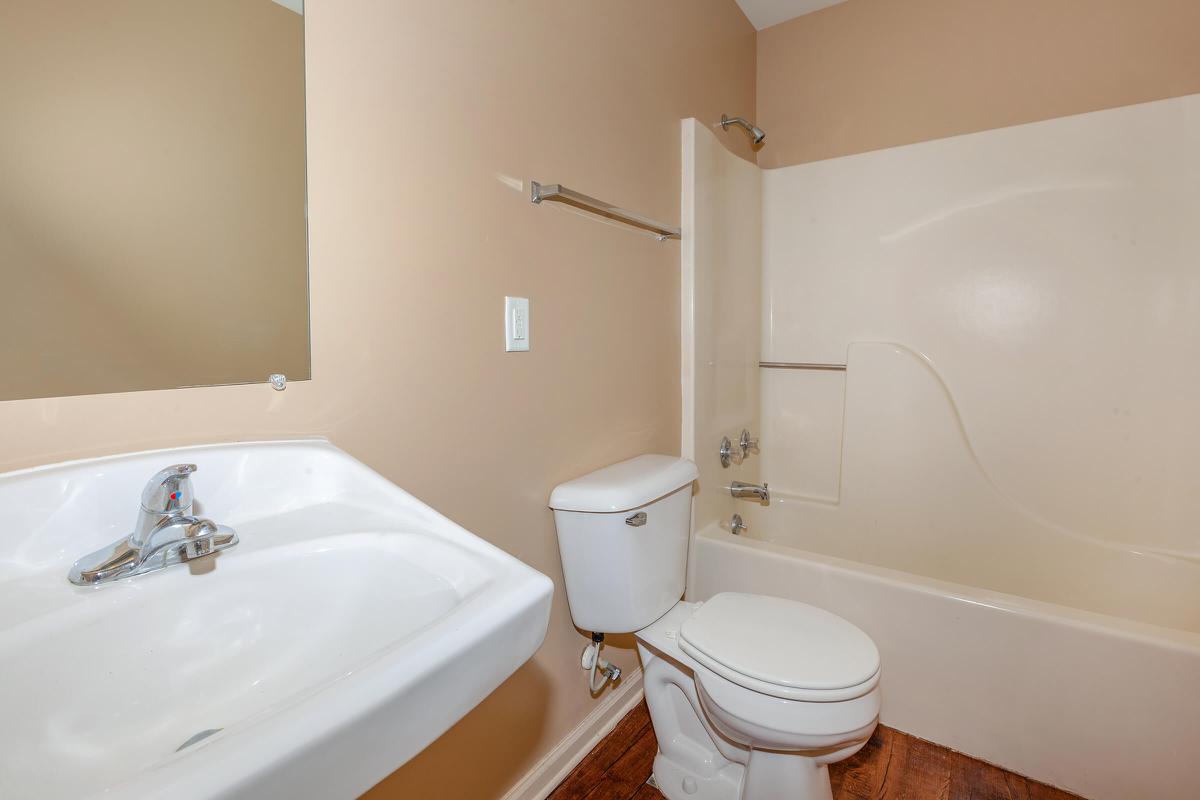 a white tub sitting next to a sink