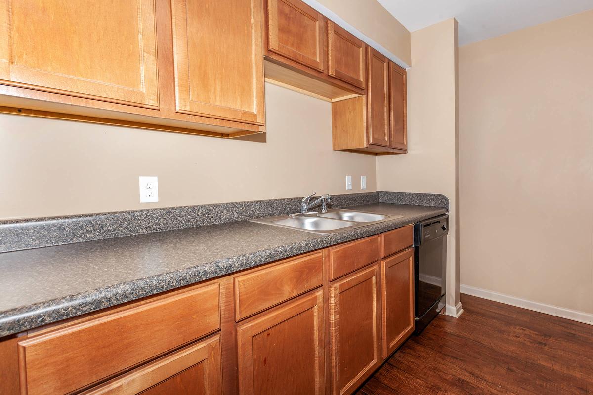 a kitchen with stainless steel appliances and wooden cabinets