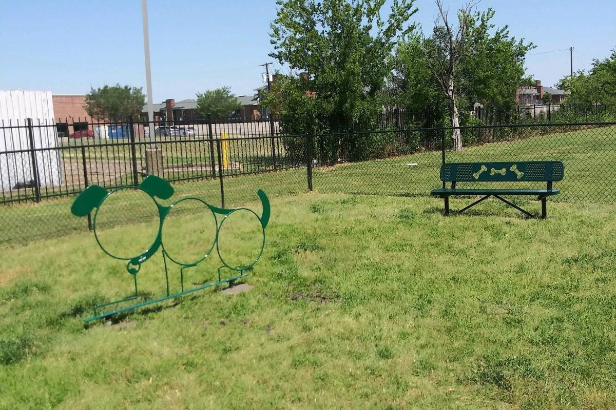 a bench in front of a green field
