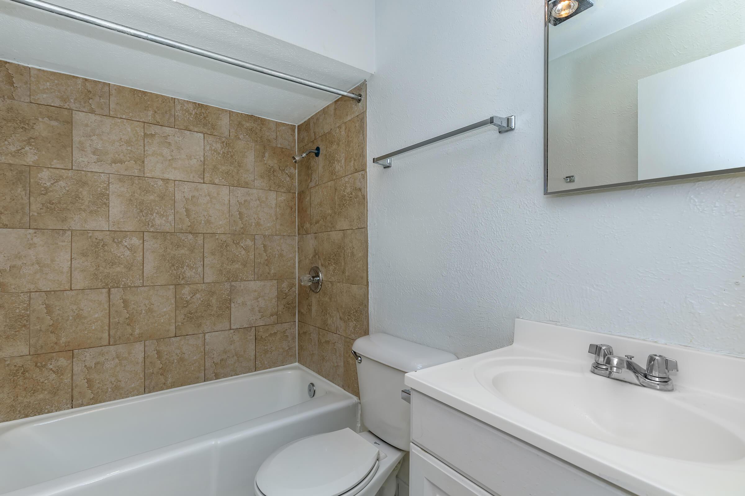 a large white tub sitting next to a sink