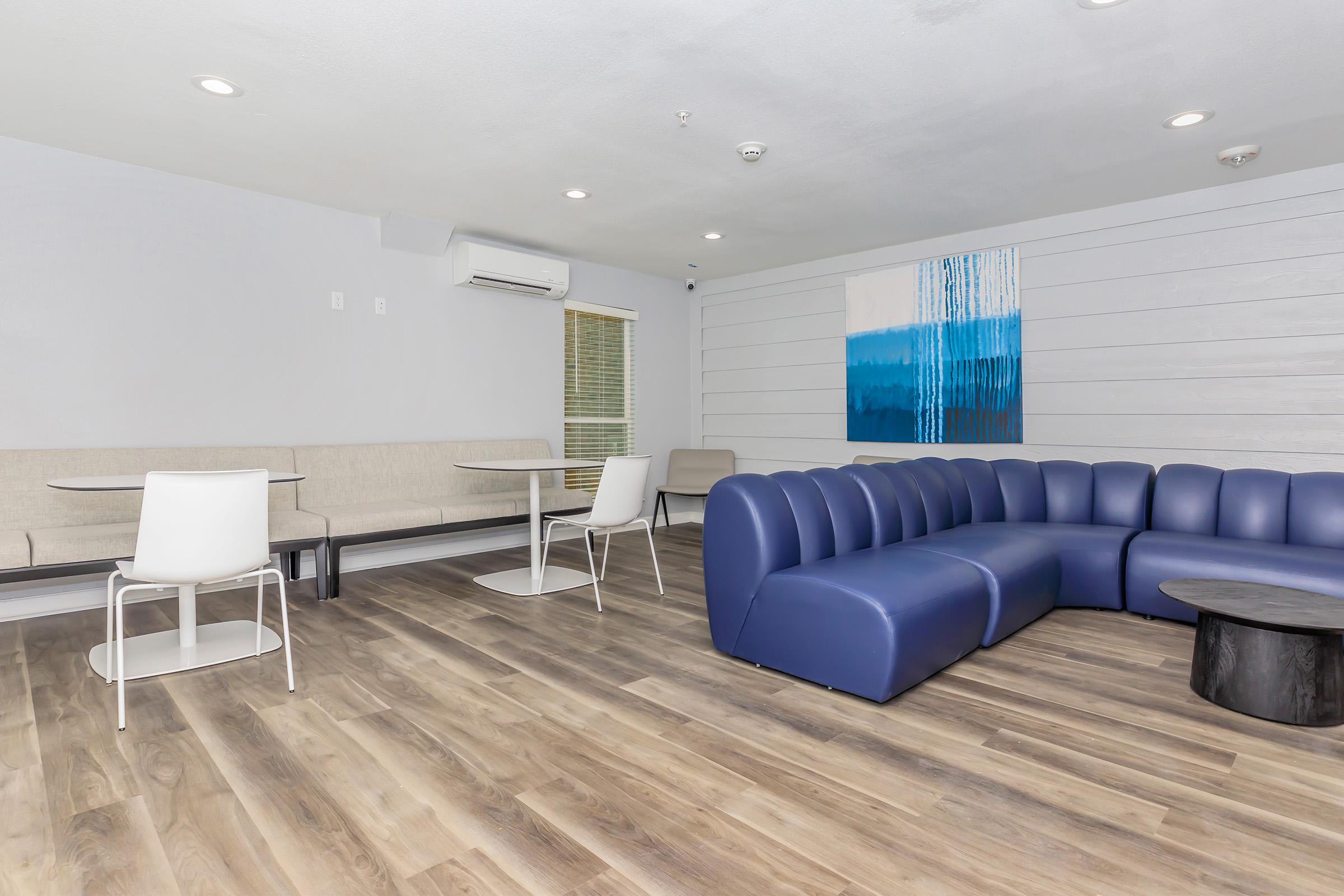 a living room filled with furniture and a wood floor