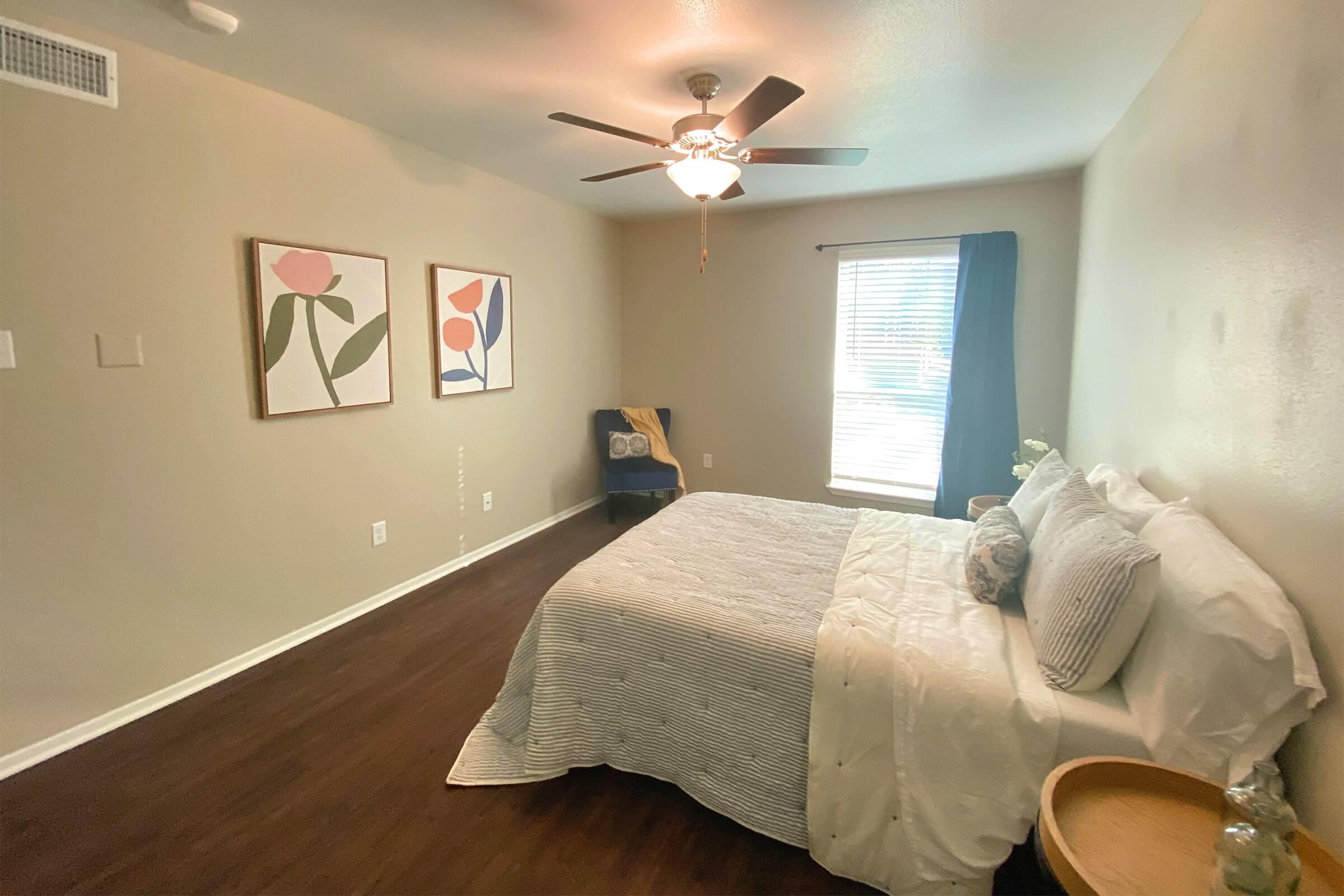 a bedroom with a bed and desk in a room