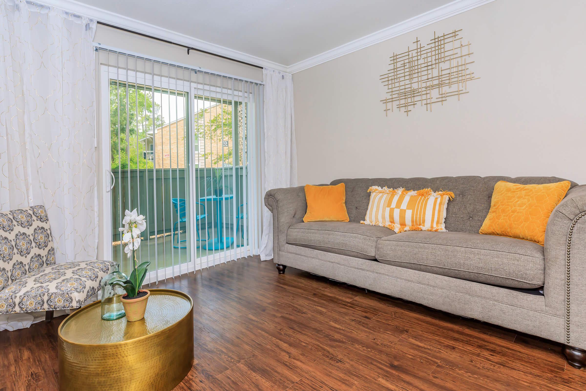 a living room filled with furniture and a large window