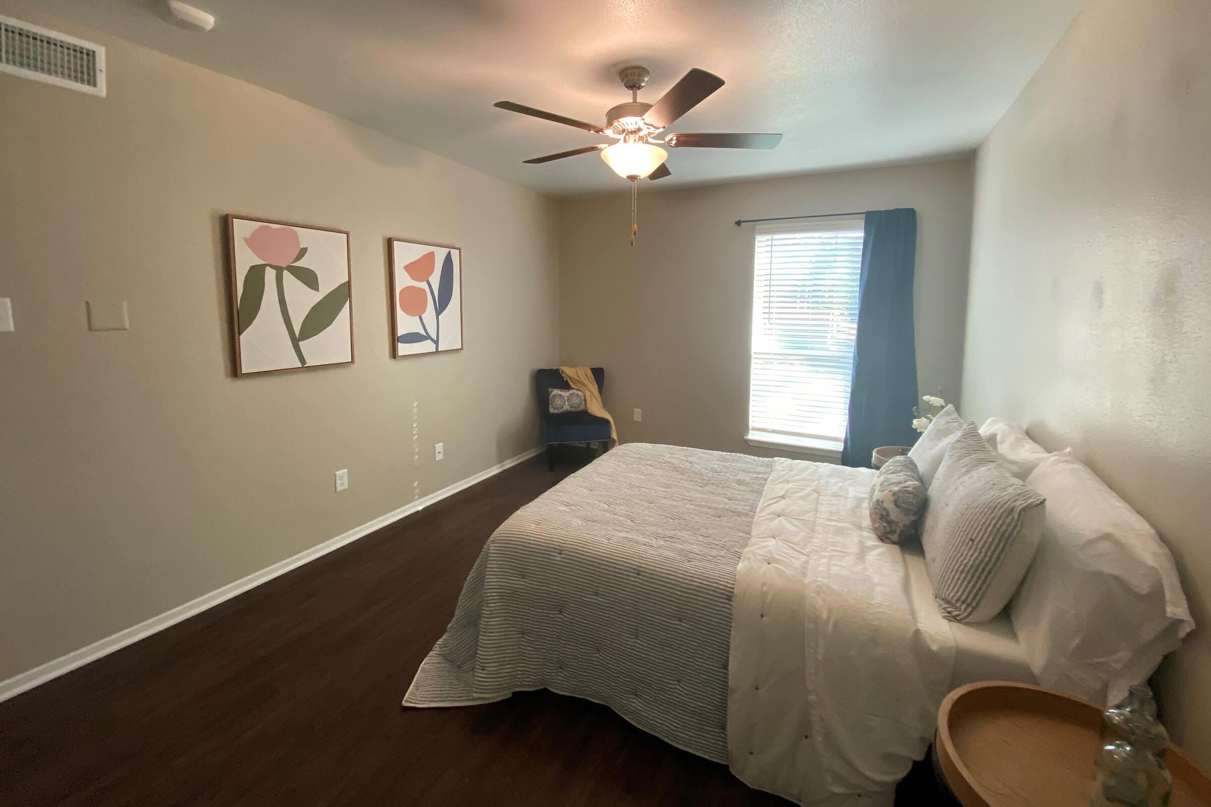 a bedroom with a bed and desk in a room