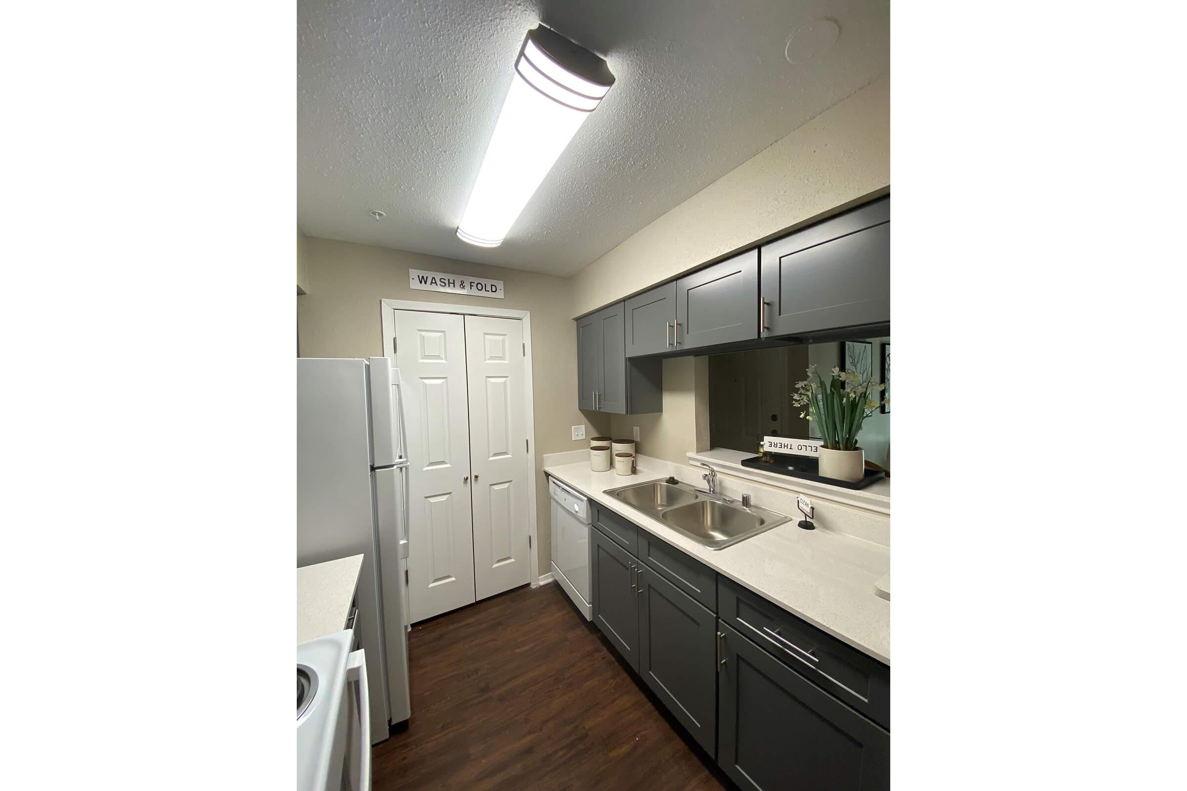 a kitchen with a sink and a refrigerator