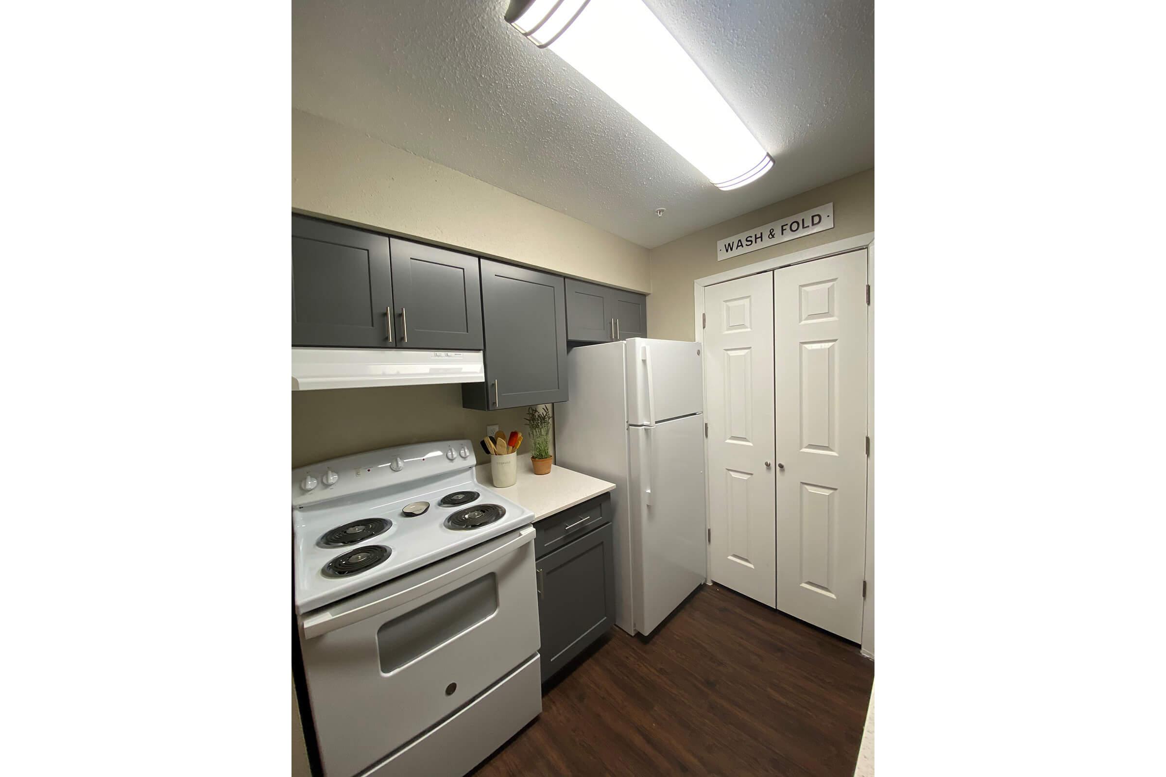 a kitchen with a stove and a refrigerator