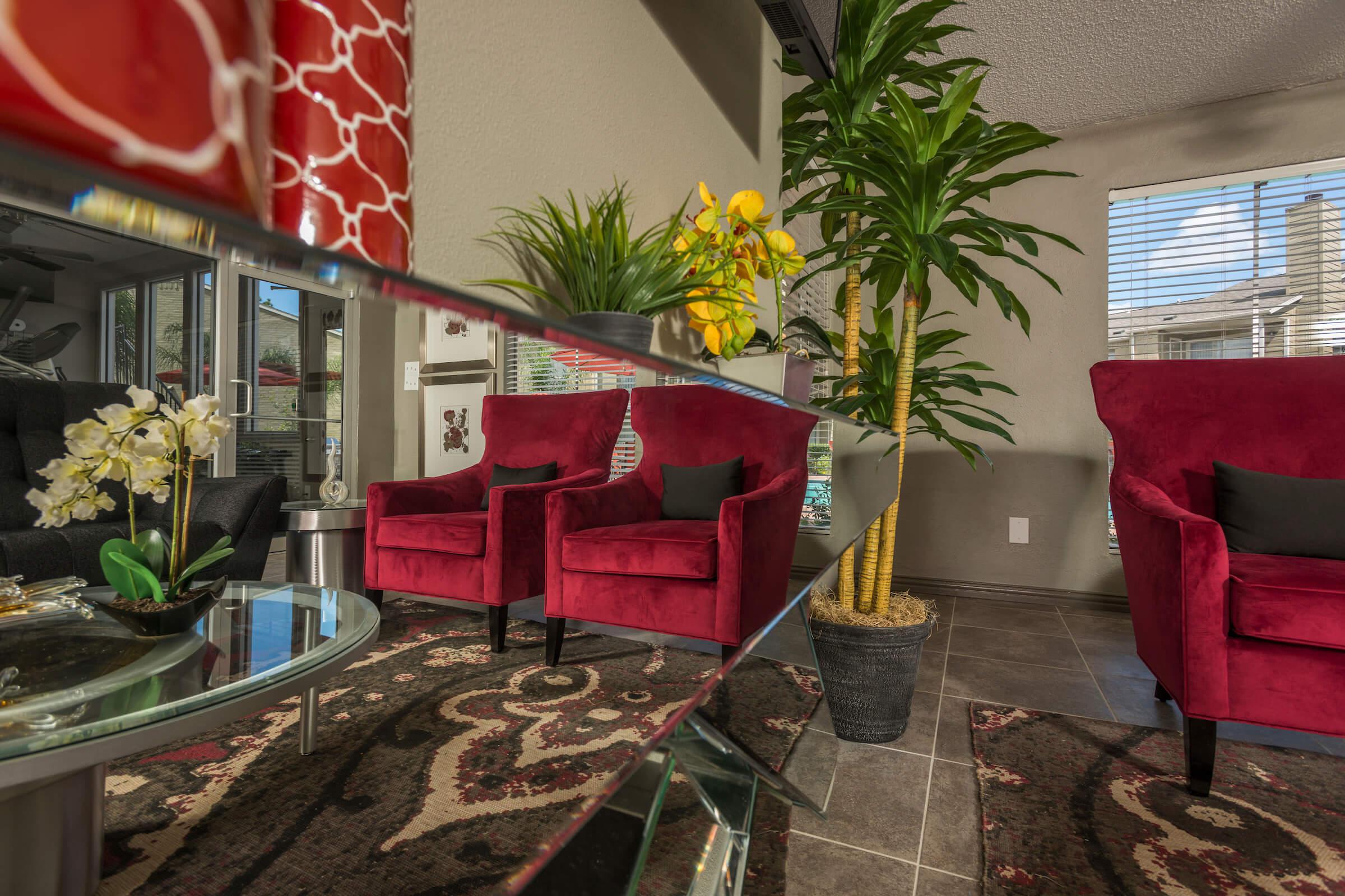 a living room filled with furniture and vase of flowers on a table