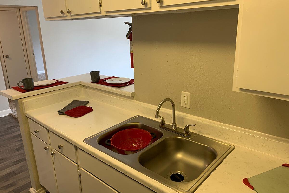 a stove top oven sitting next to a sink