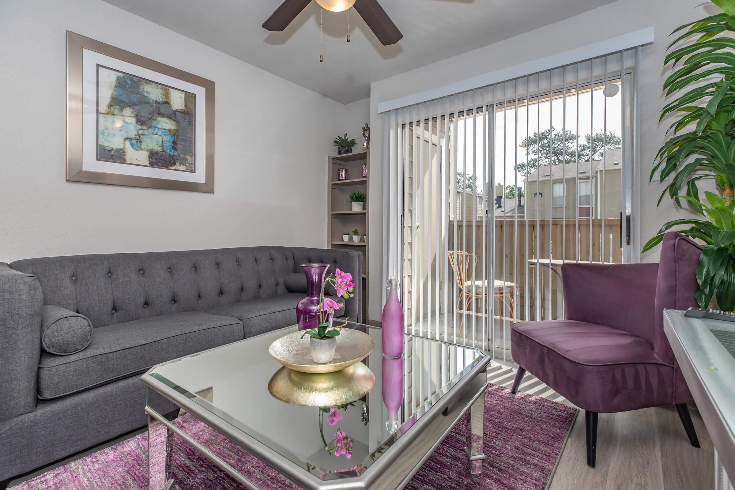 a living room filled with furniture and a large window