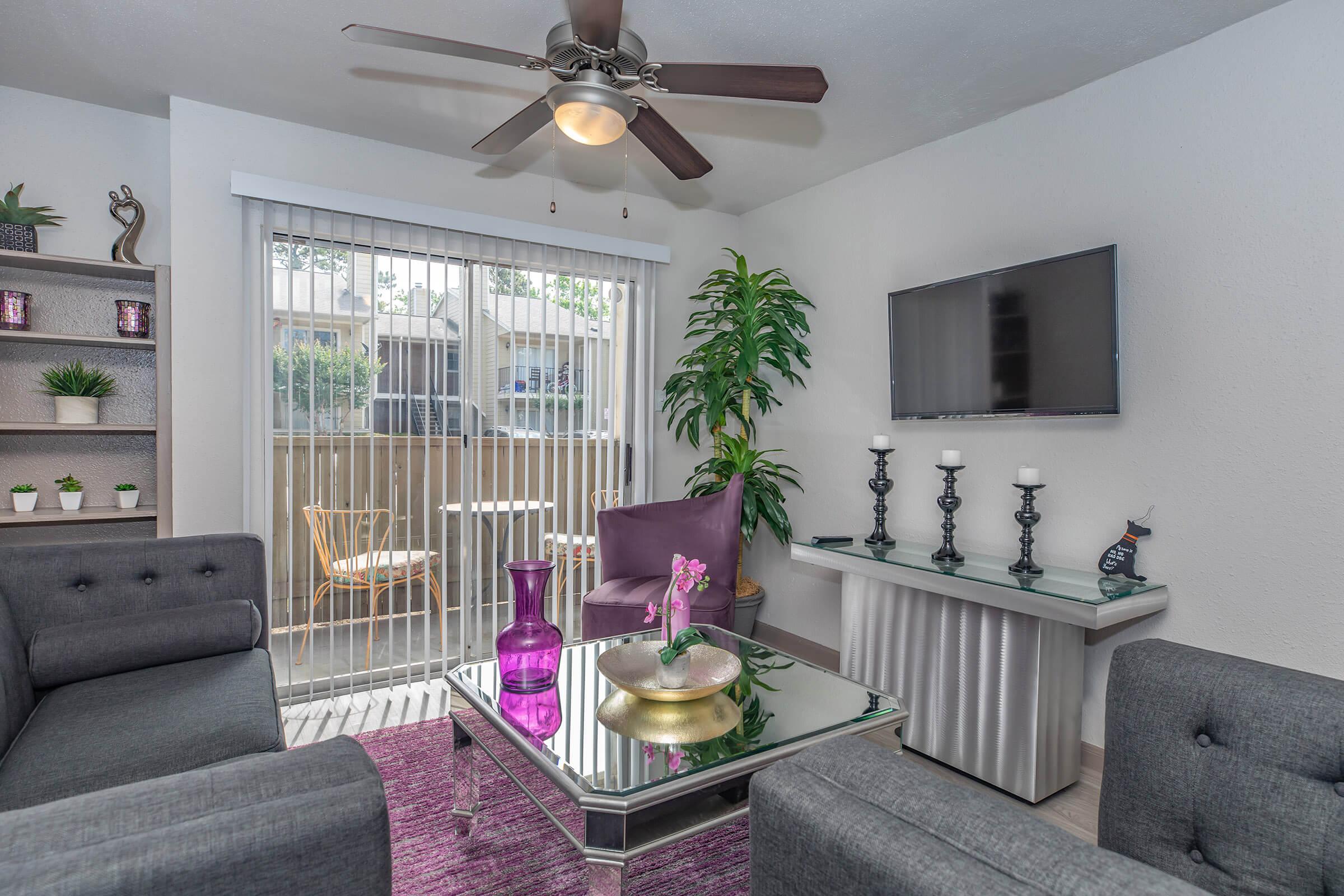 a living room filled with furniture and vase of flowers on a table