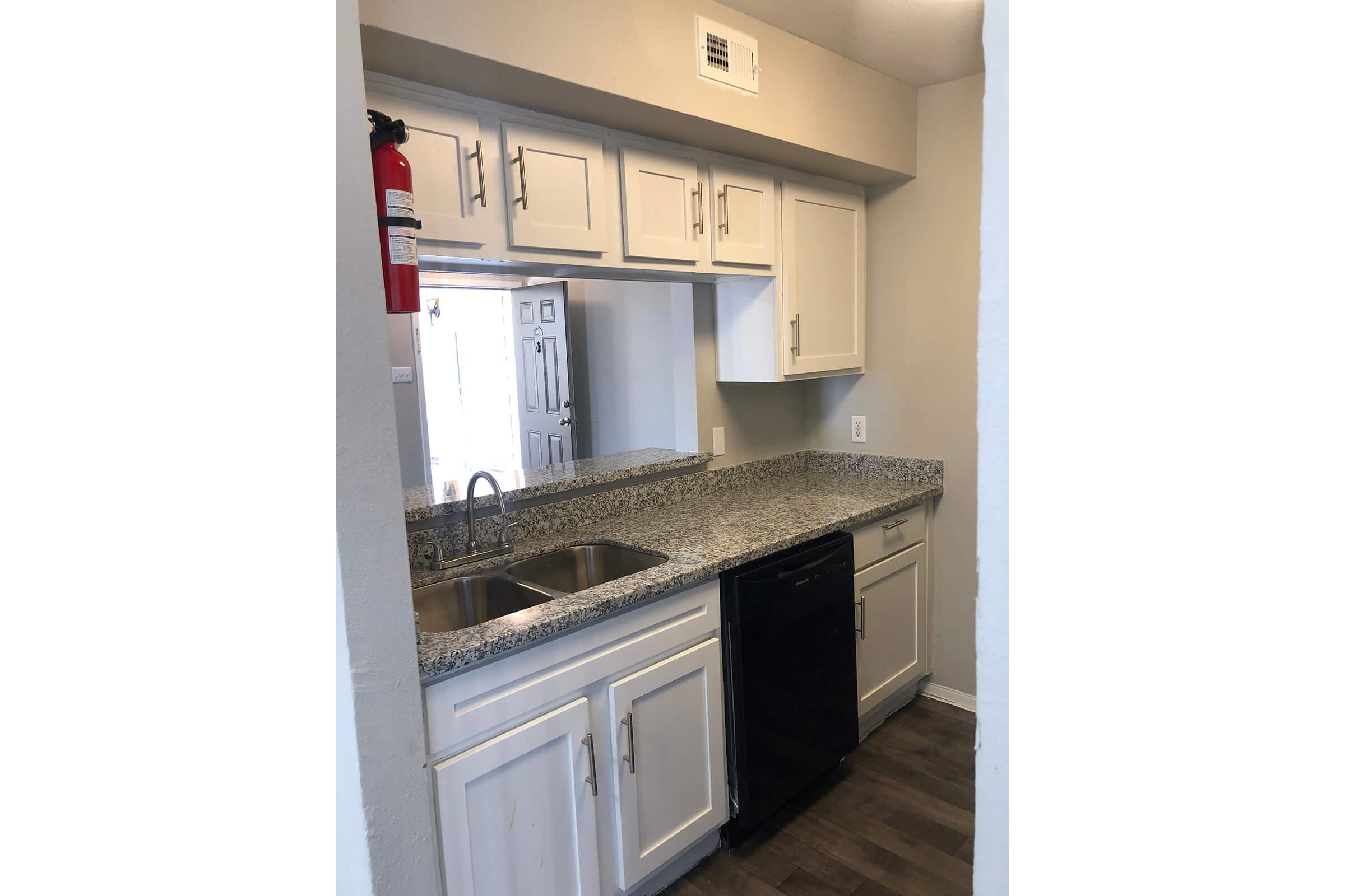 a kitchen with a sink and a refrigerator