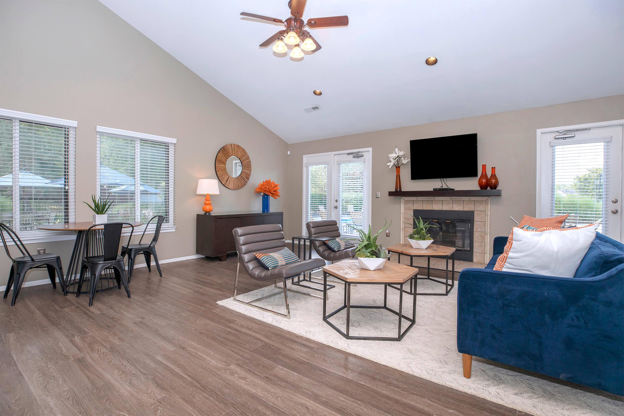 a living room filled with furniture and a large window