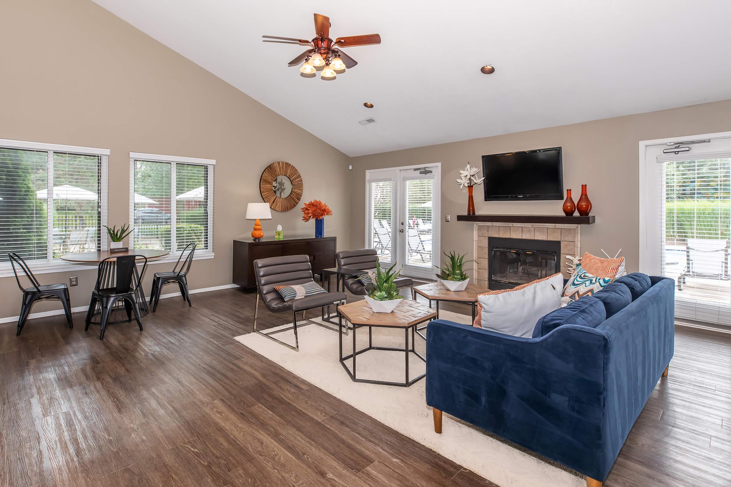 a living room filled with furniture and a large window