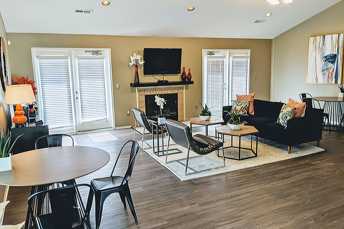 a living room filled with furniture and a large window