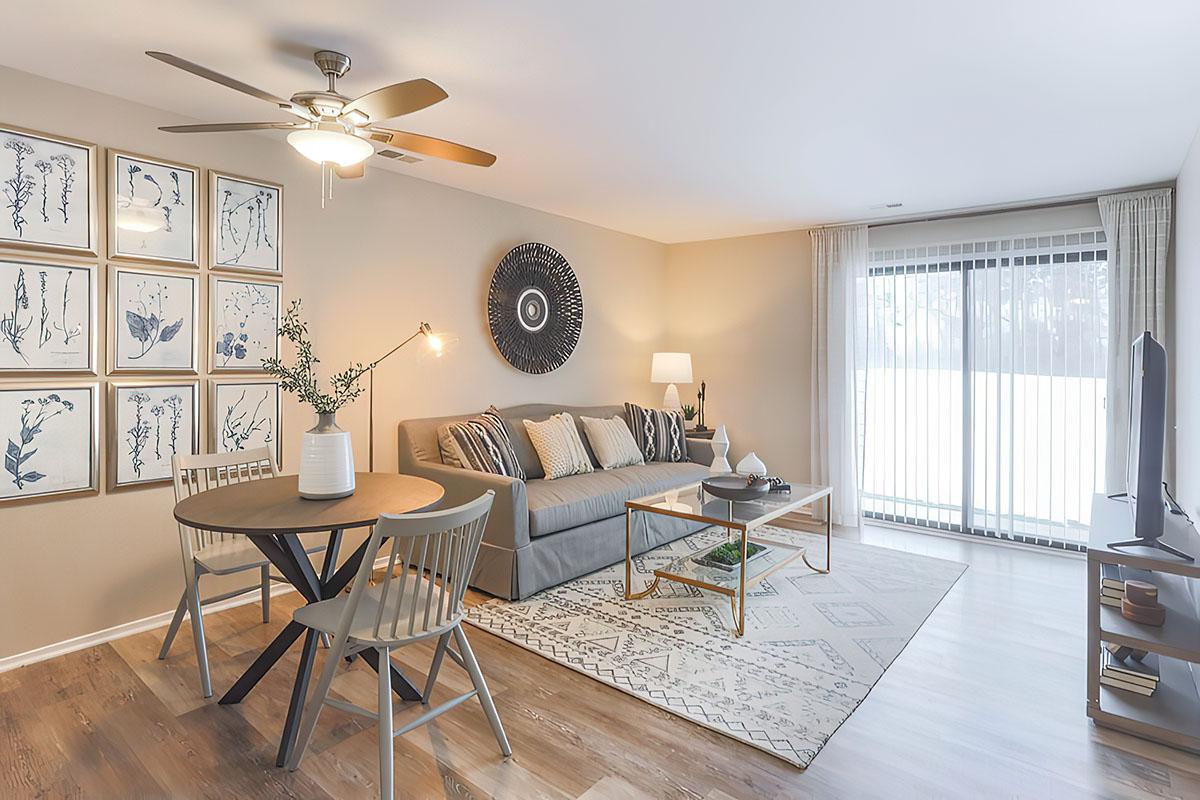 a living room filled with furniture and a large window