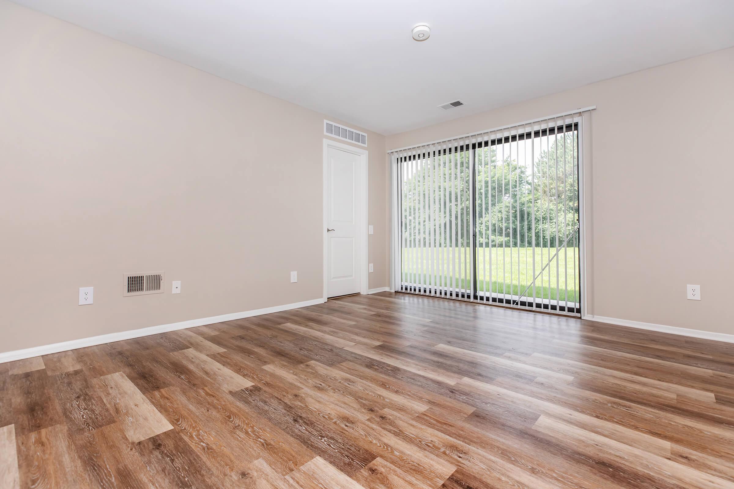 a large empty room with a wooden floor