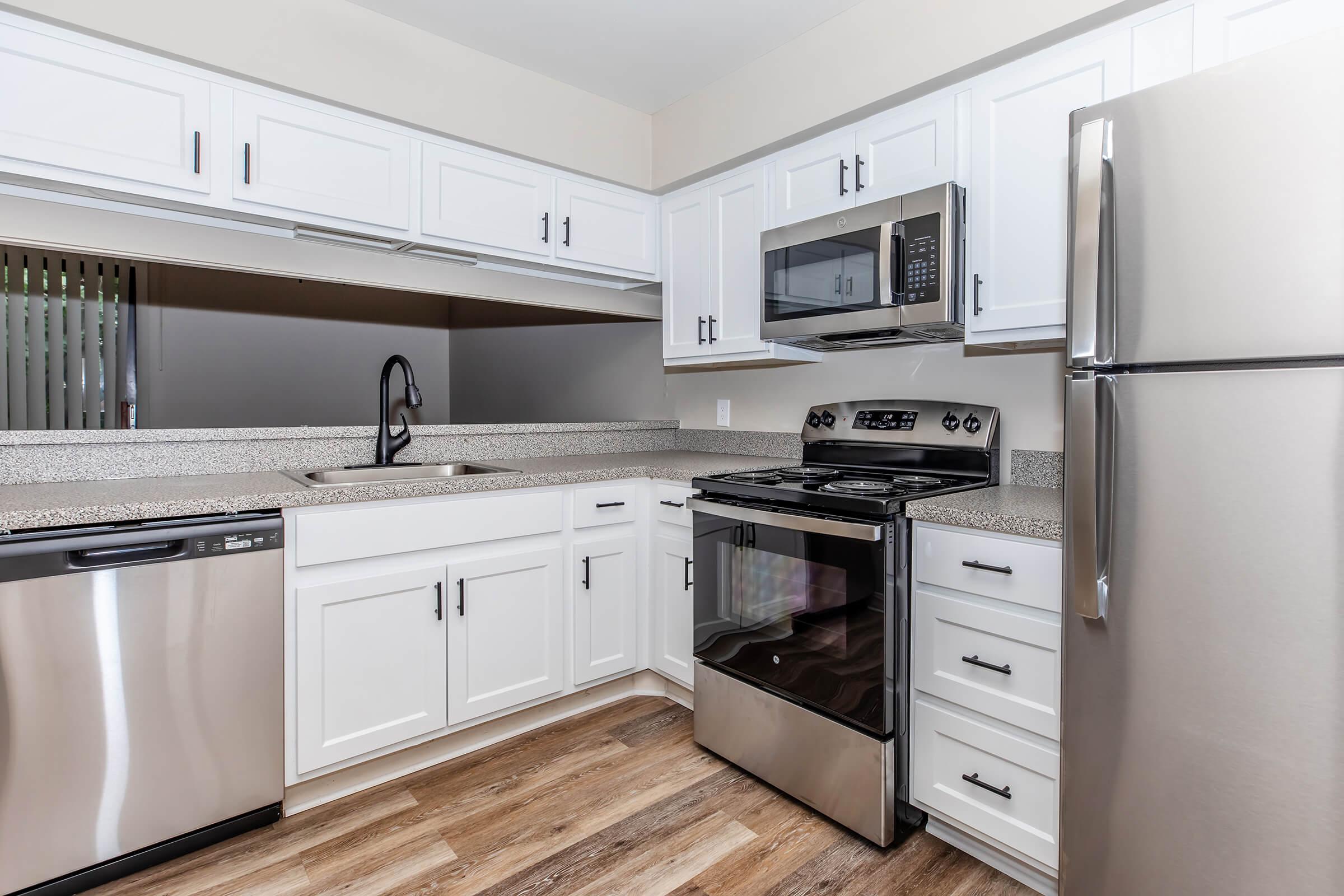 a kitchen with a stove and a refrigerator