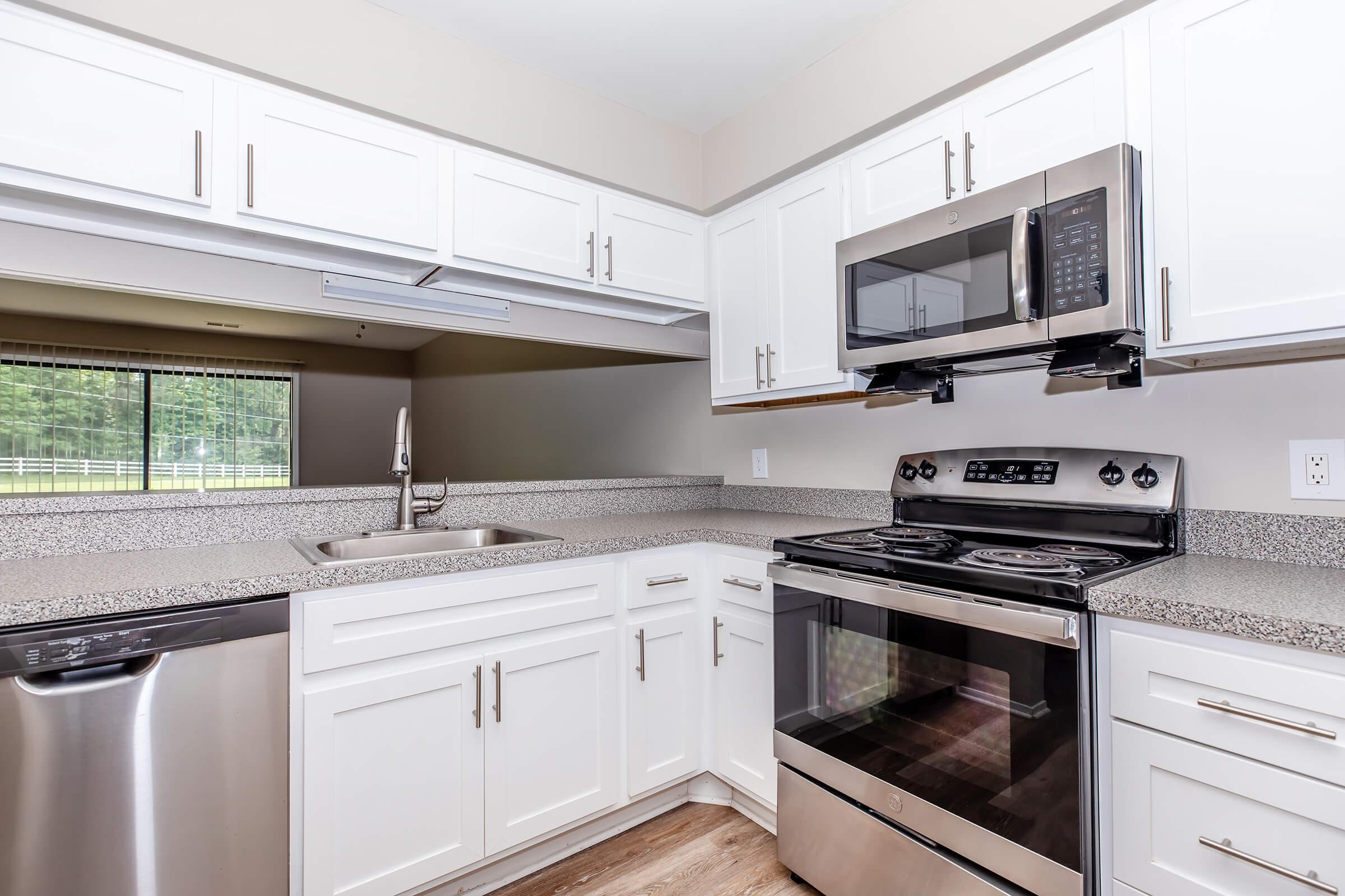 a kitchen with a stove and a microwave