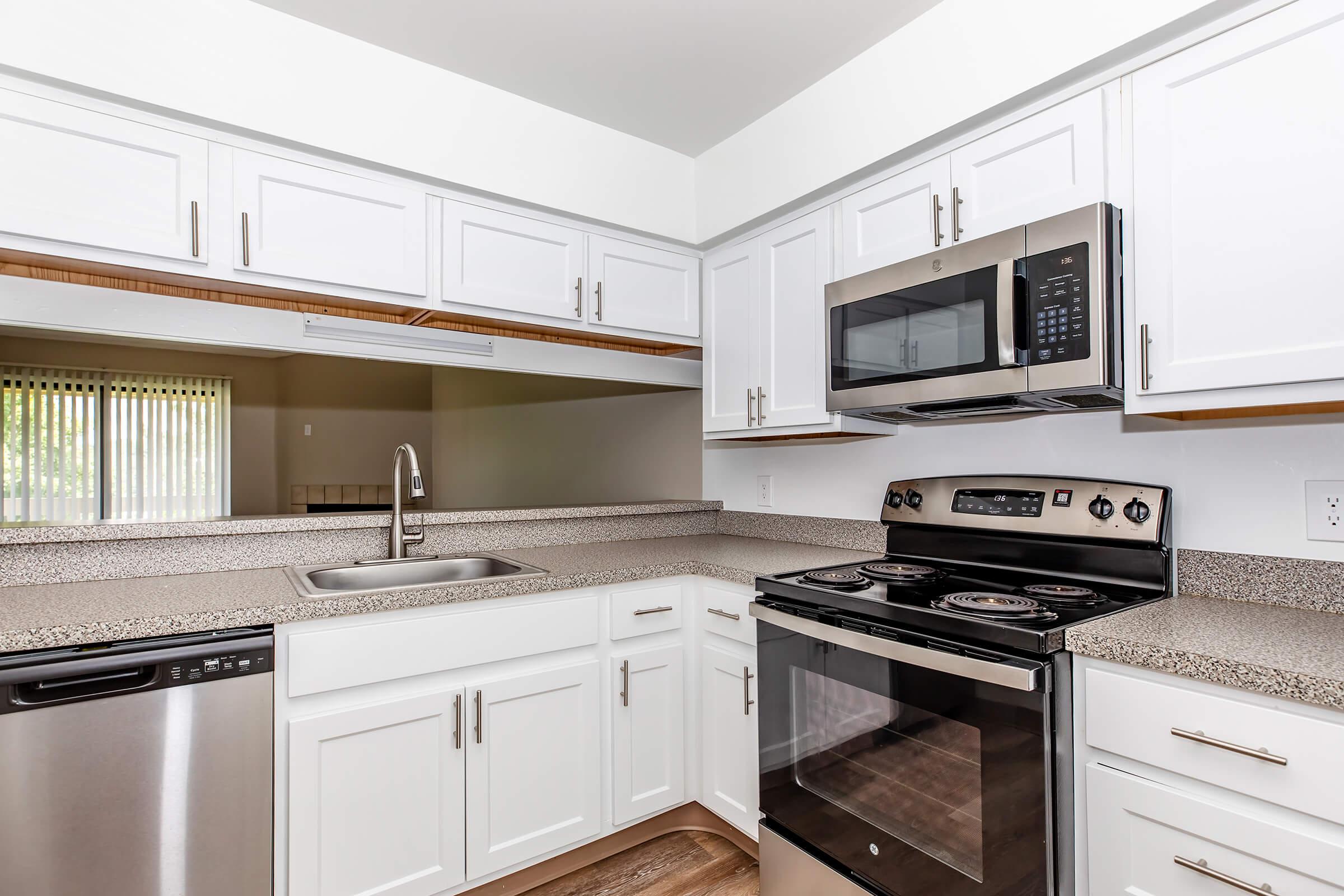 a kitchen with a stove and a microwave