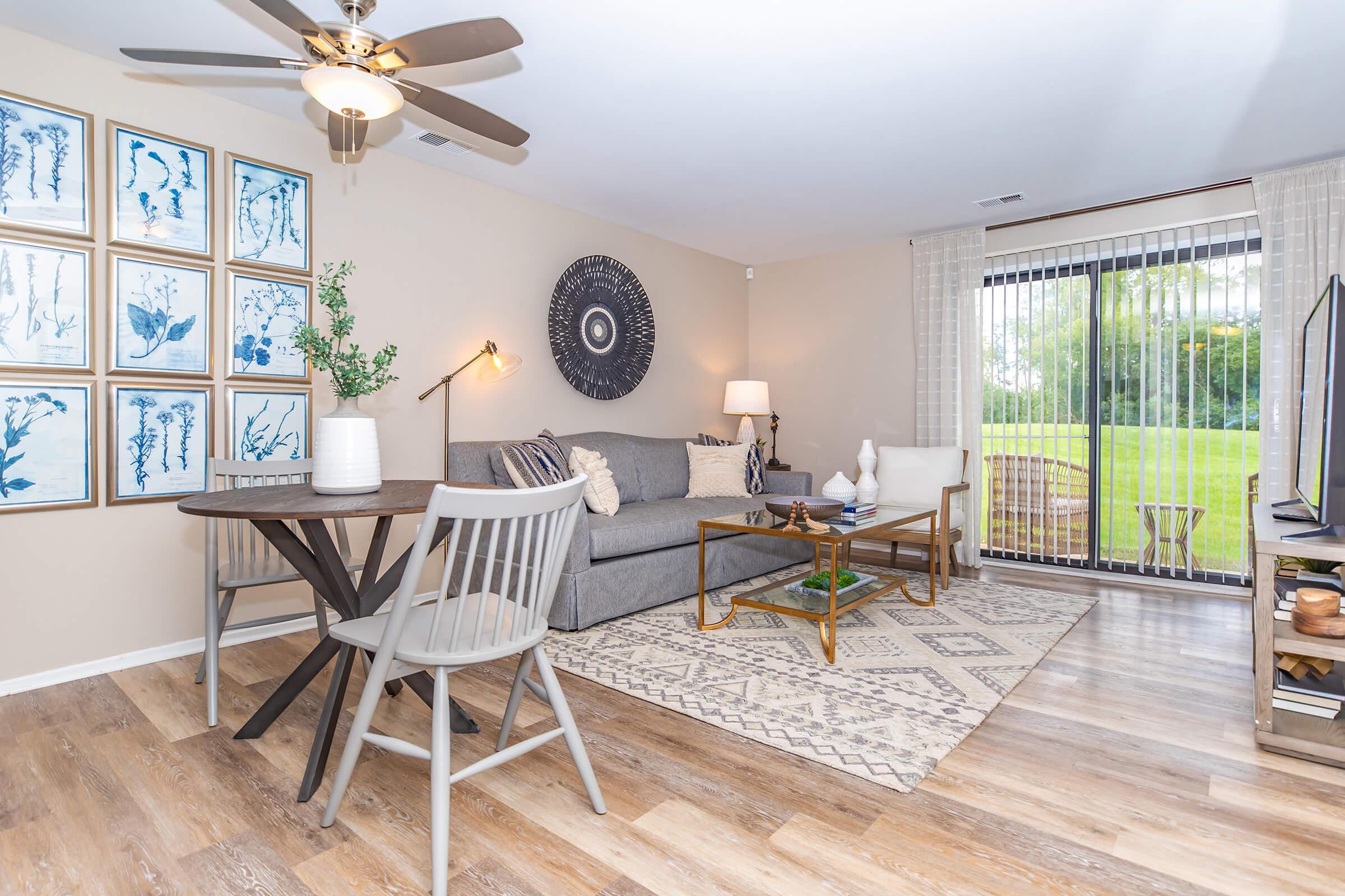 a living room filled with furniture and a large window