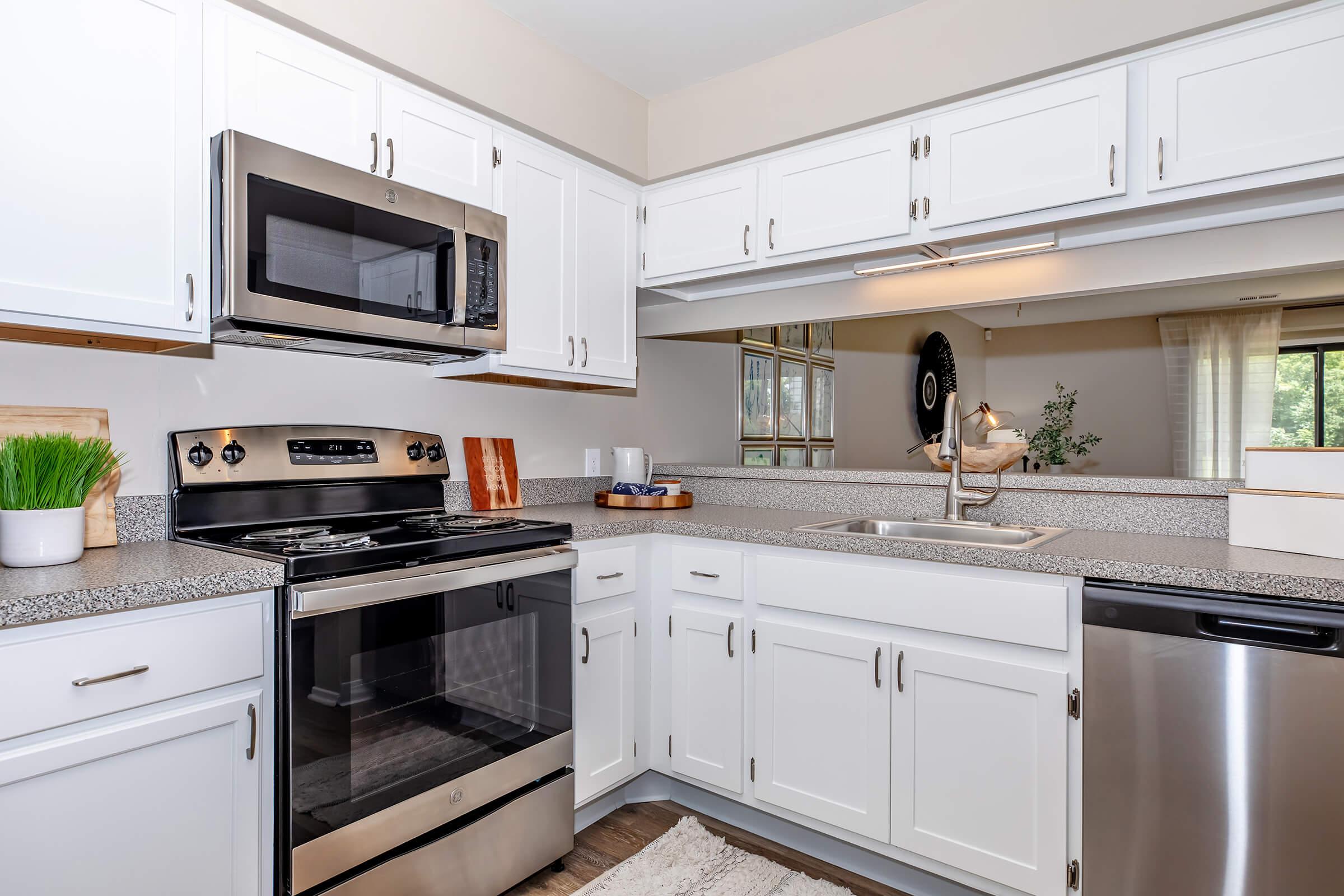 a kitchen with a stove a sink and a microwave