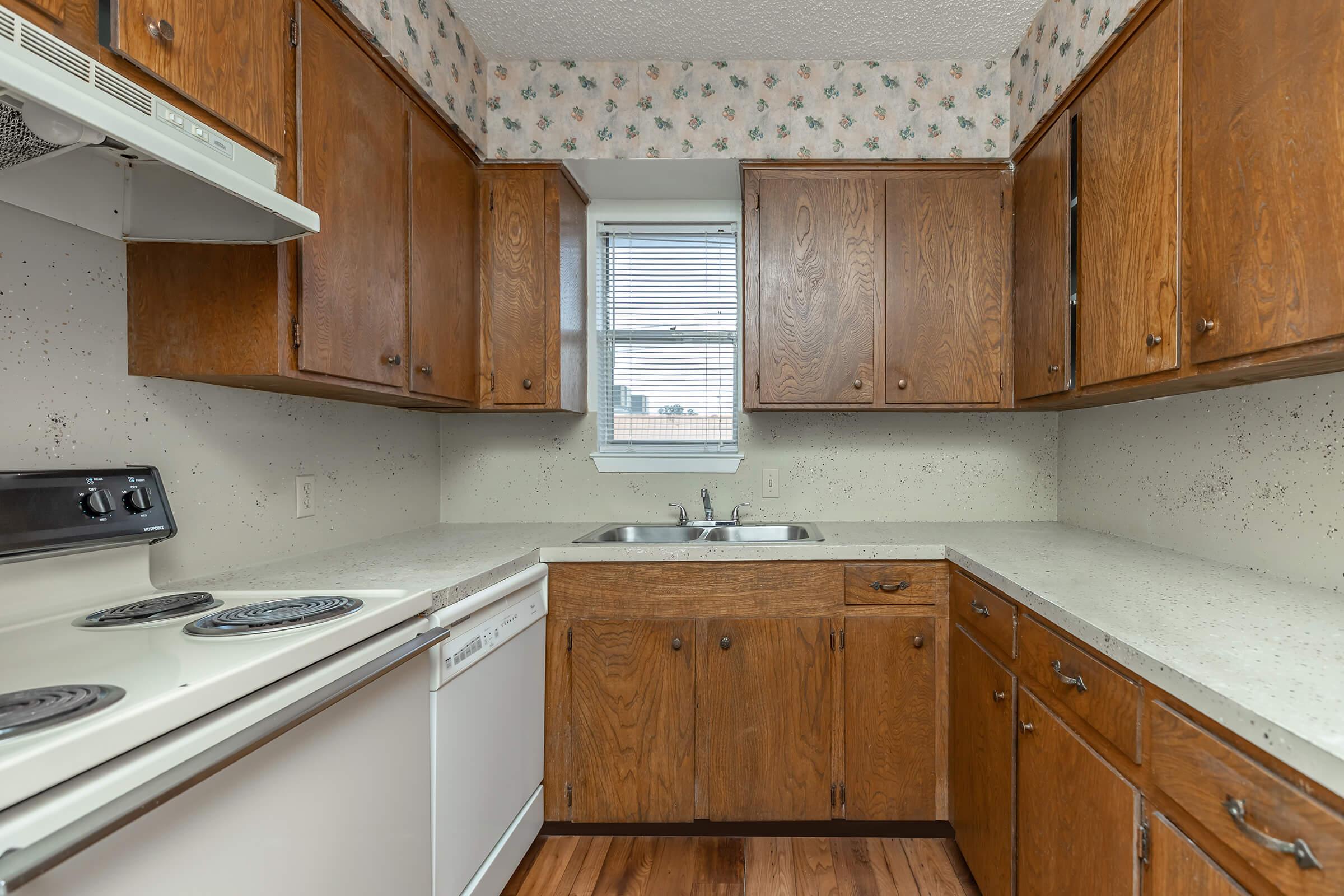 a kitchen with wooden cabinets and a microwave