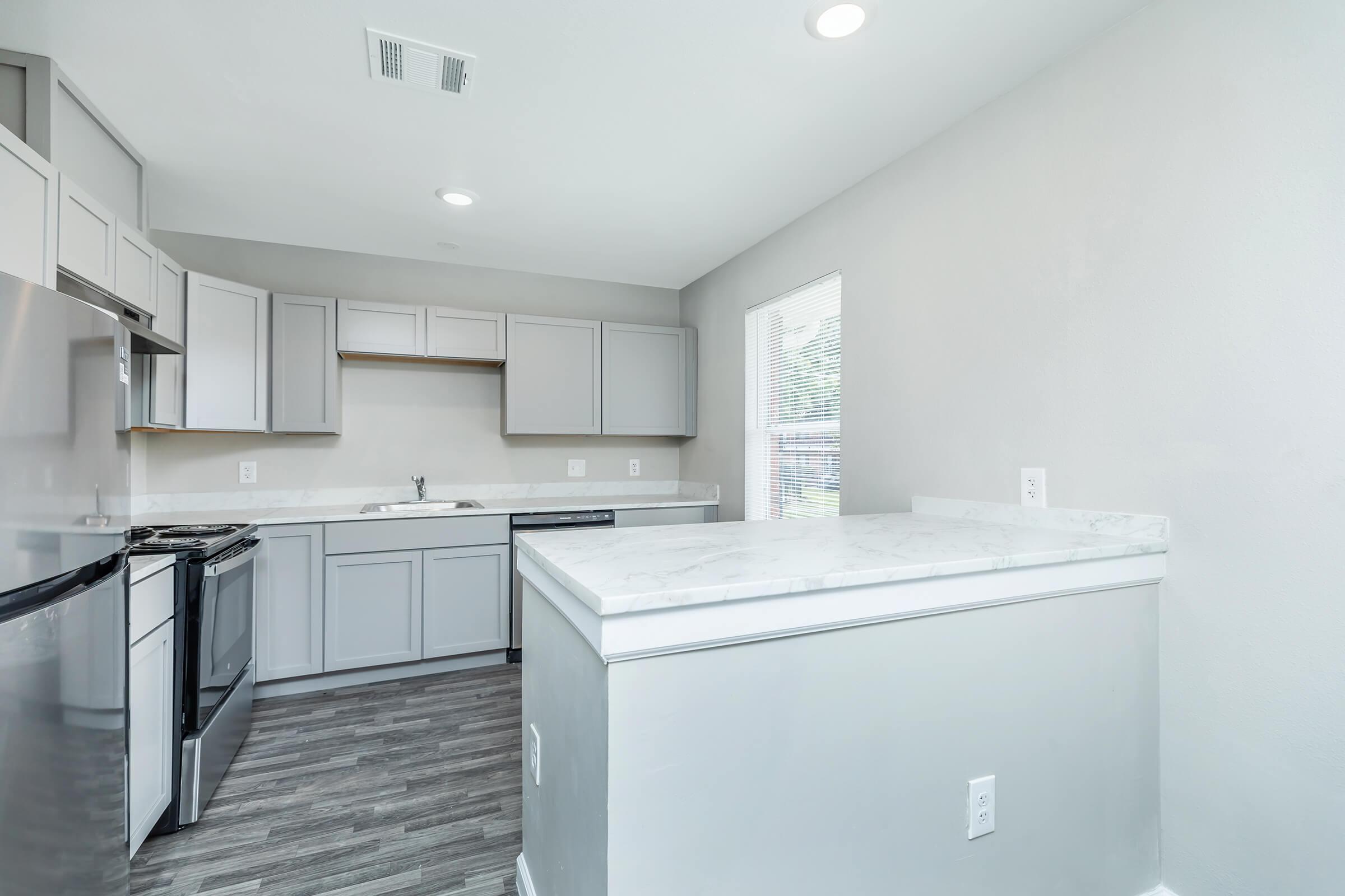 a kitchen with a sink and a refrigerator