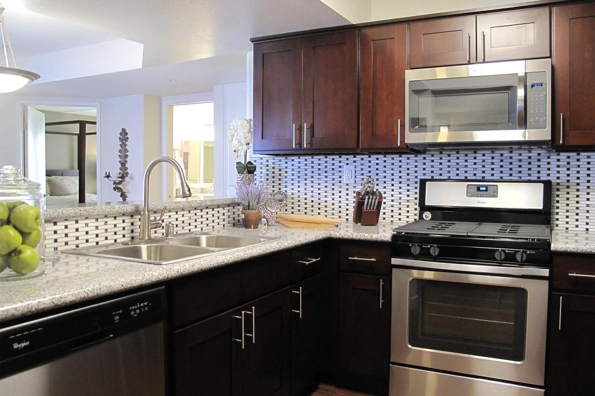 a kitchen with stainless steel appliances and wooden cabinets