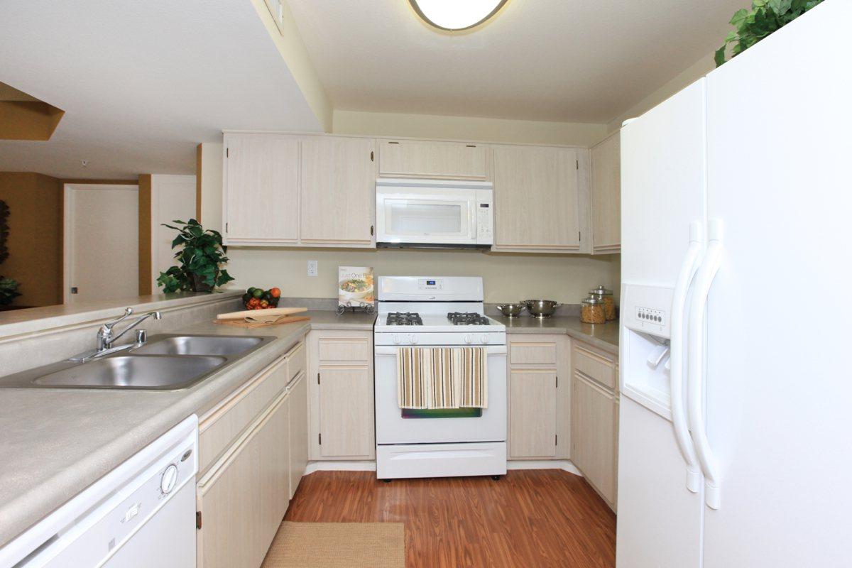 a white stove top oven sitting inside of a kitchen