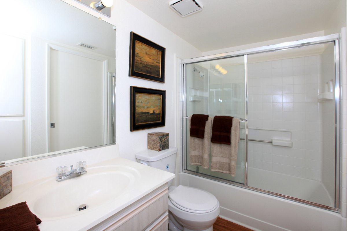 a large white tub next to a sink
