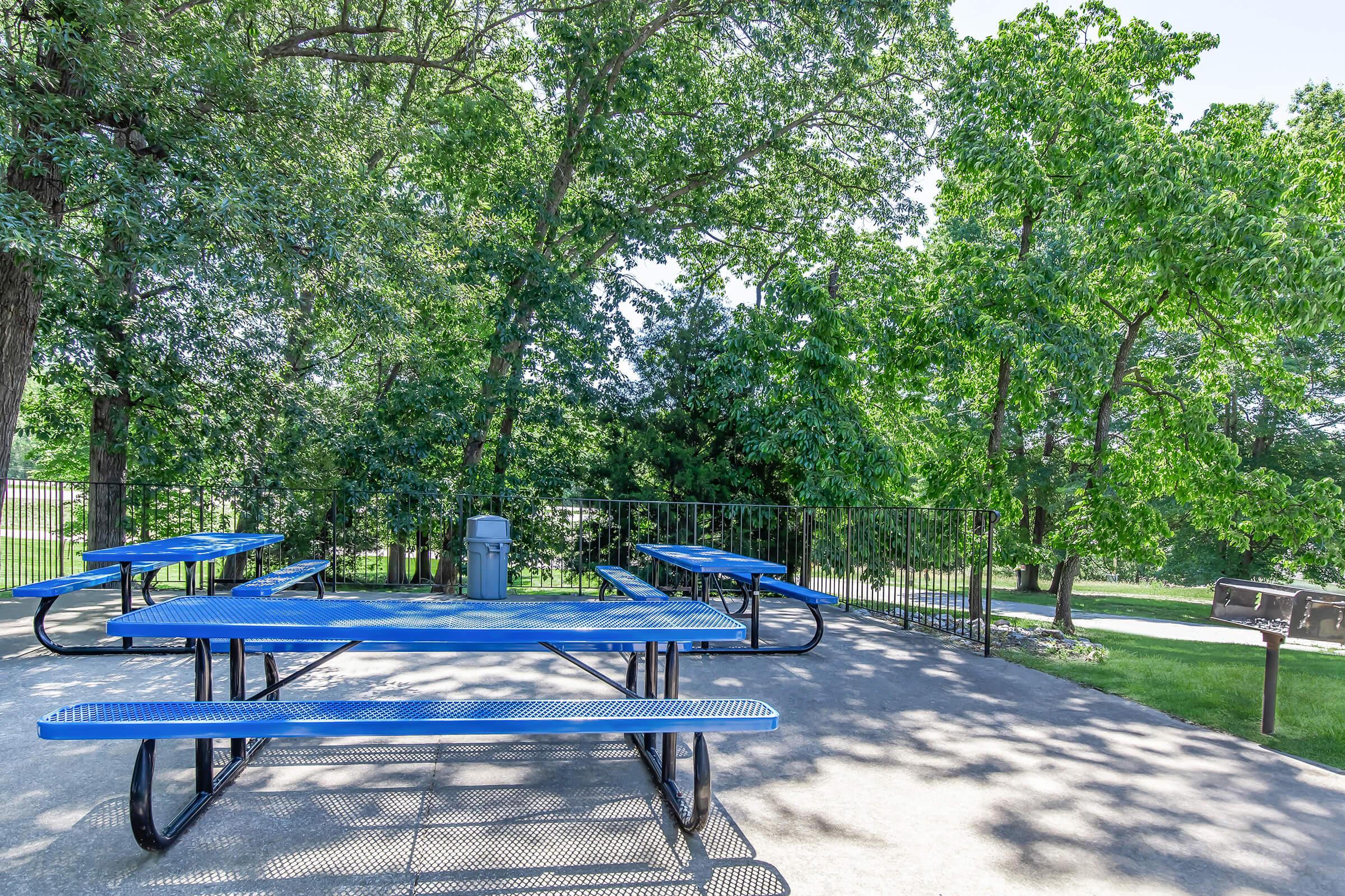 a blue bench in a park