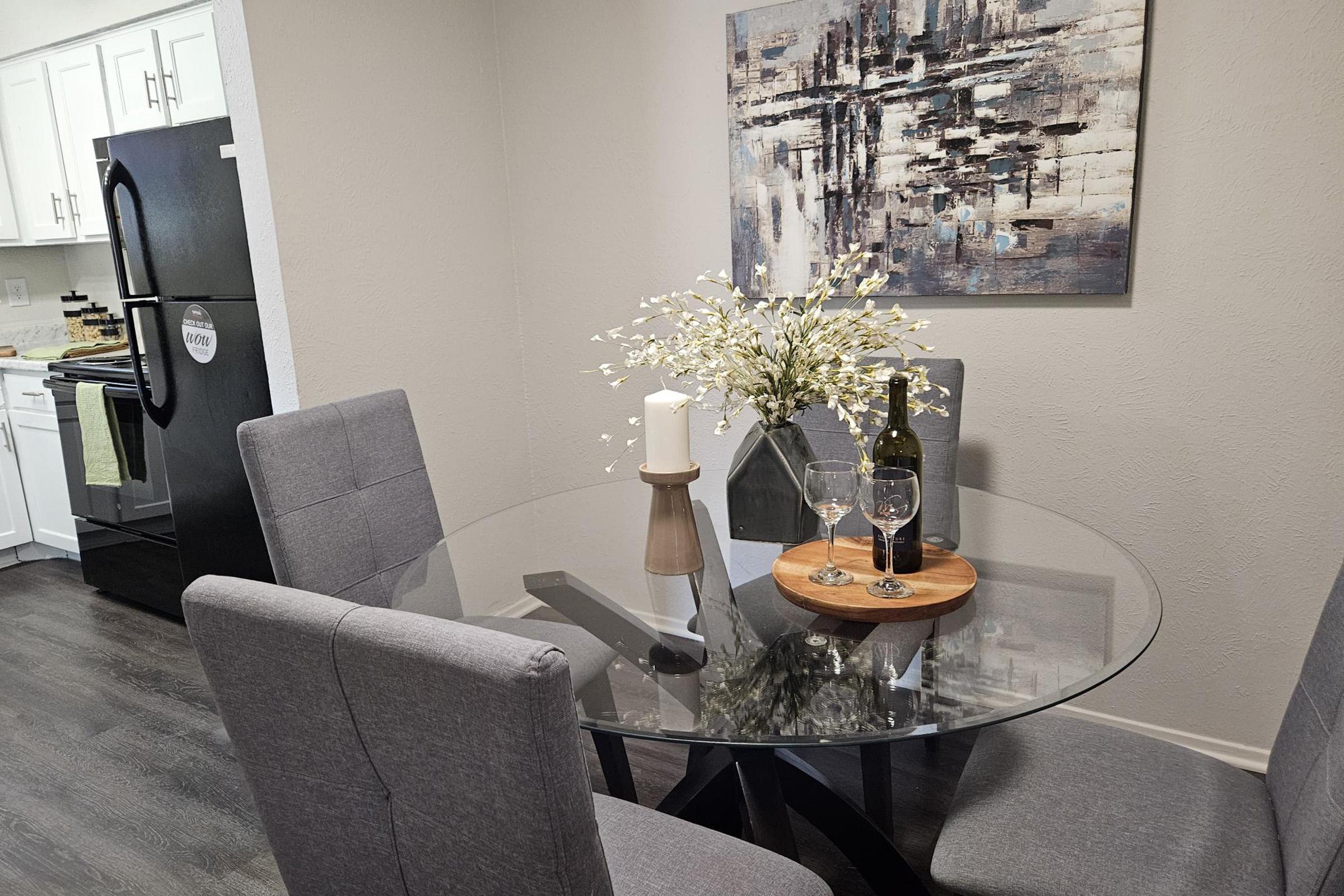 a living room filled with furniture and vase of flowers on a table