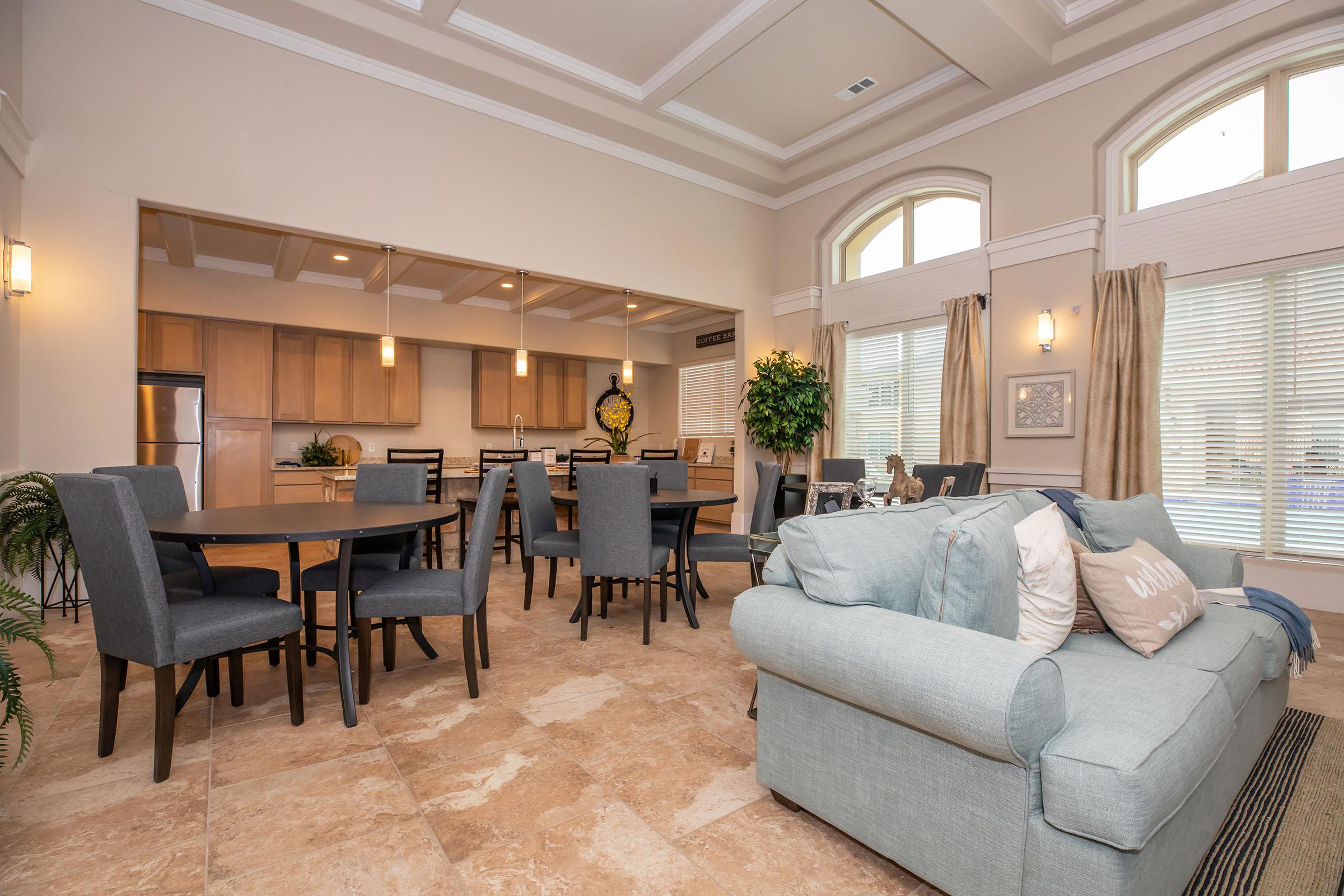 a living room filled with furniture and a large window