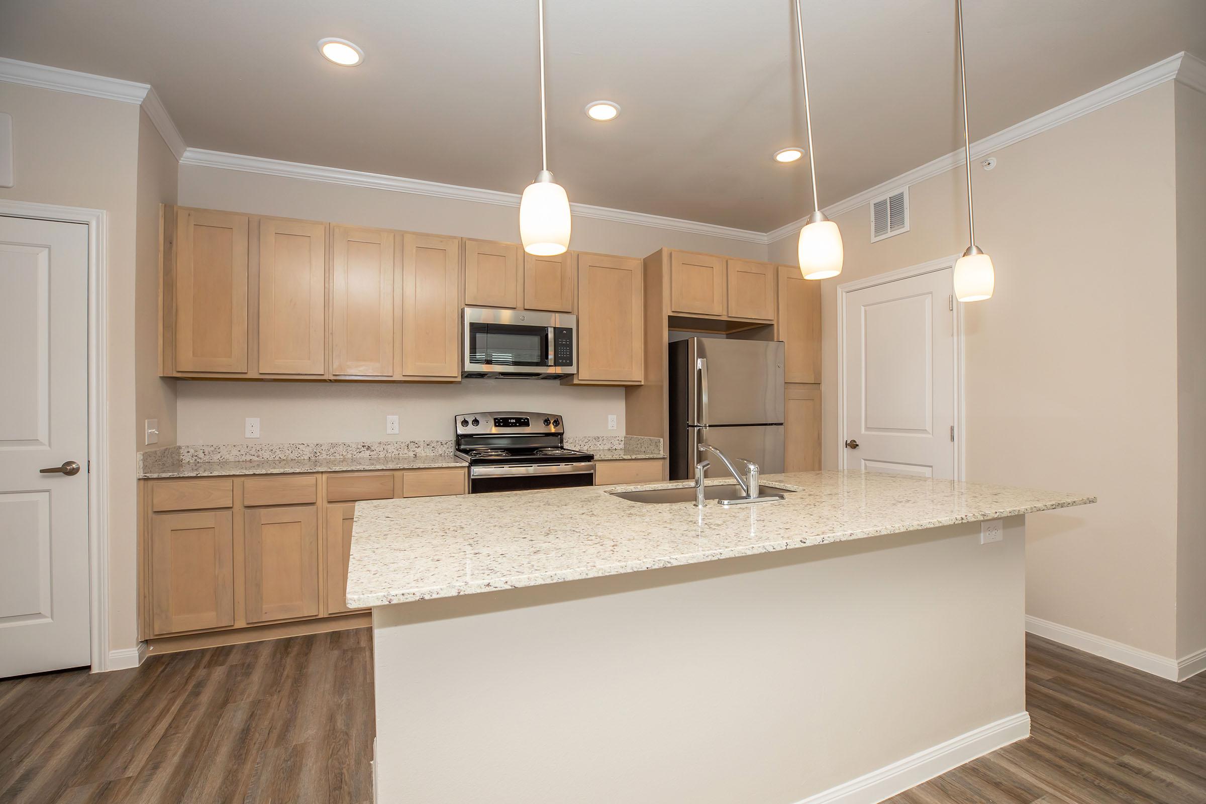 a kitchen with a sink and a refrigerator