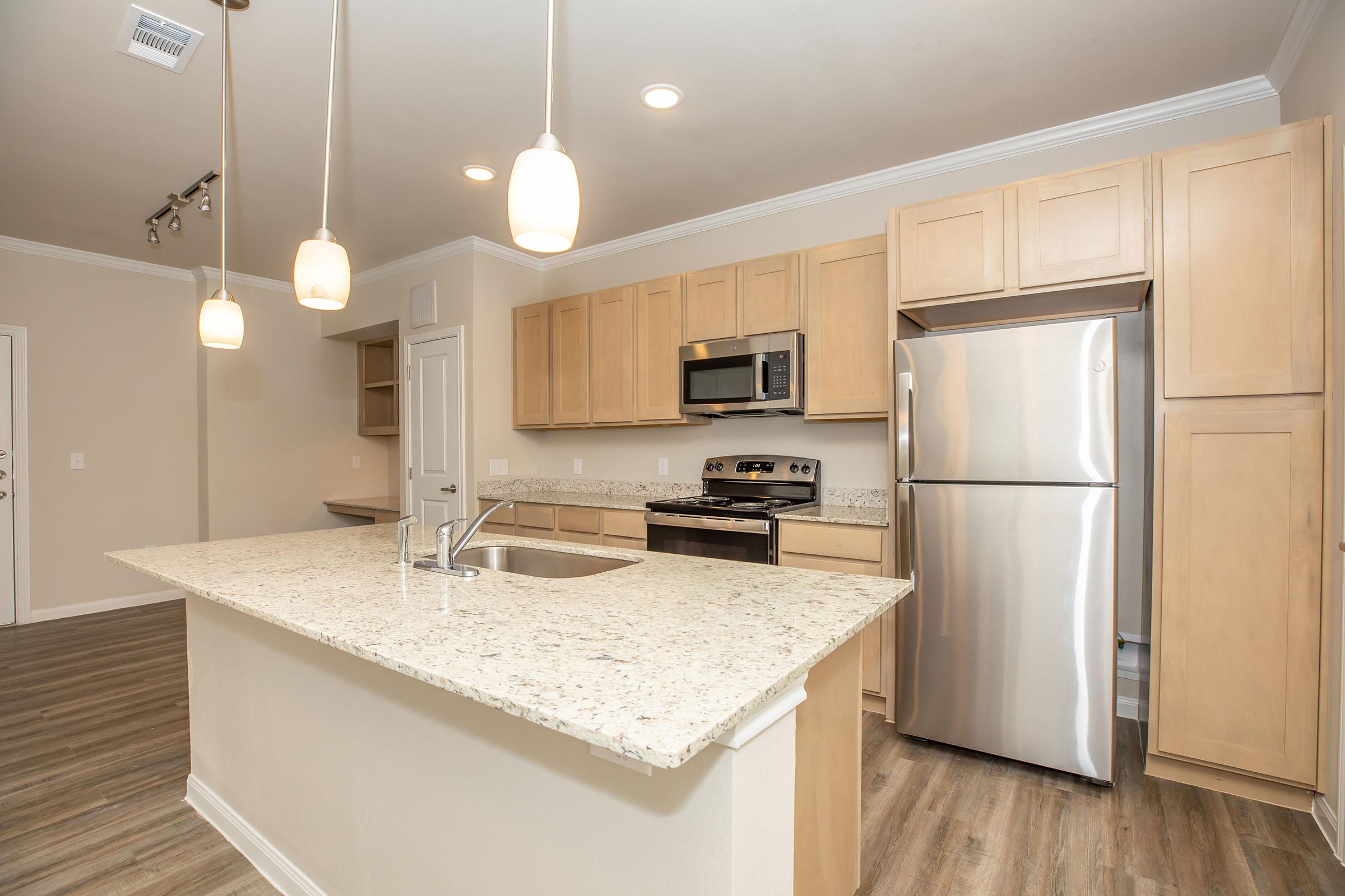 a kitchen with a sink and a refrigerator