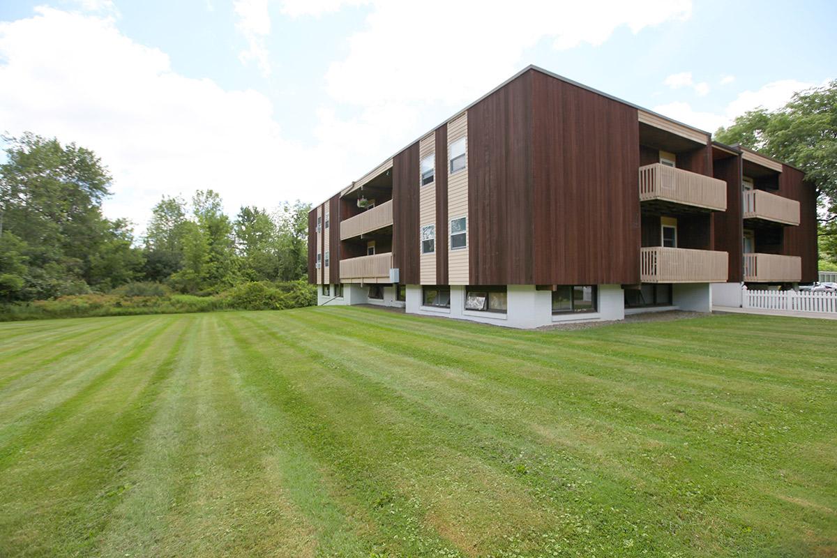 a building with a grassy field
