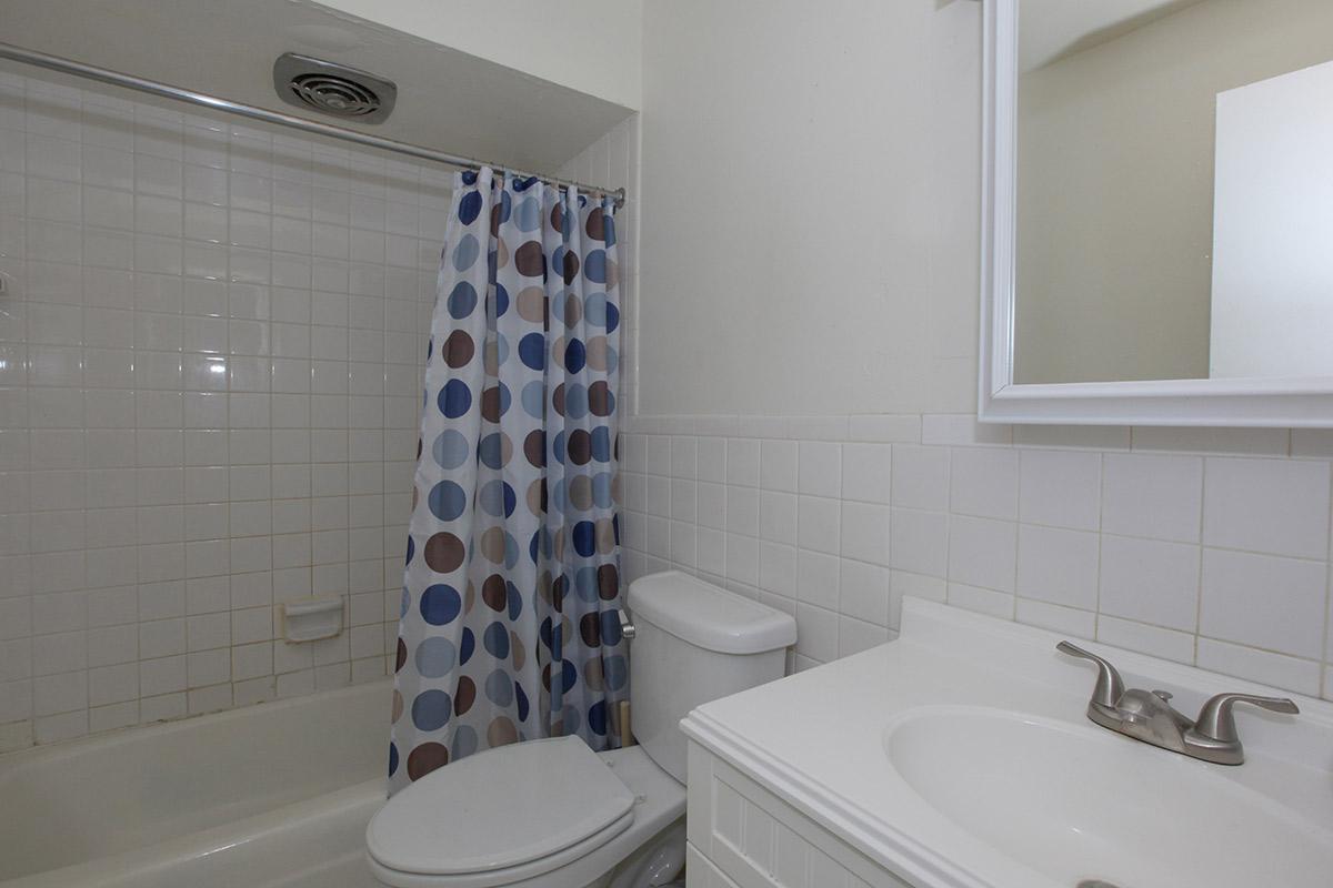 a white tub sitting next to a sink