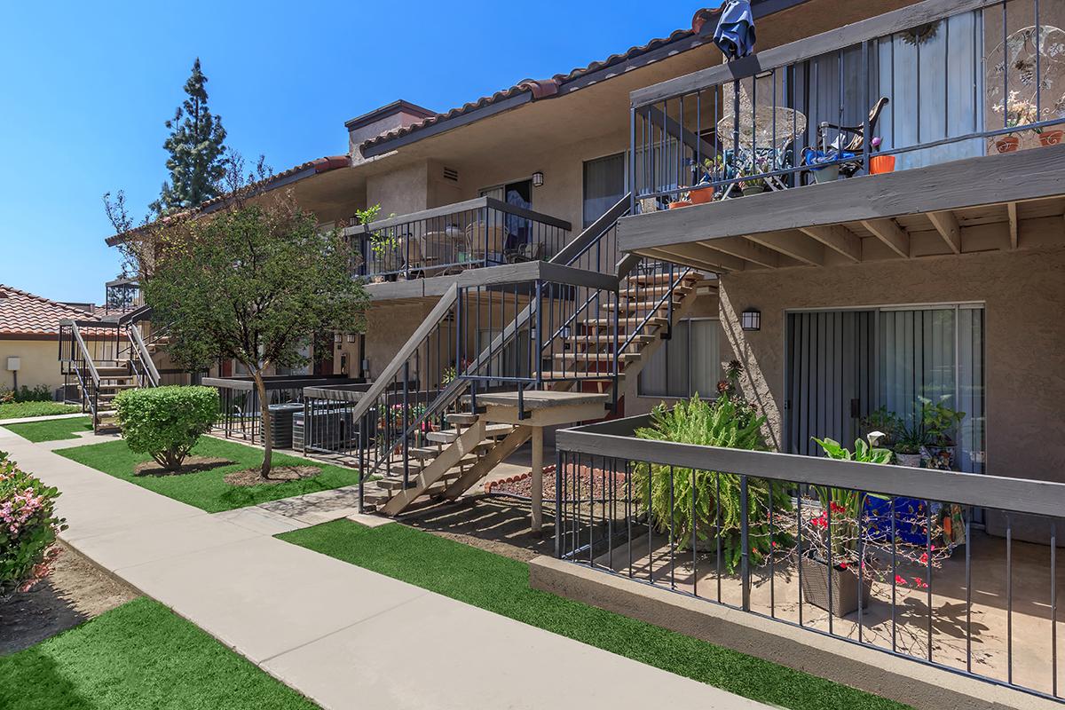 a house with a fence in front of a building