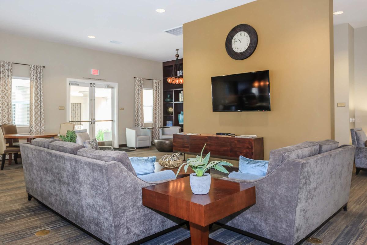 a living room filled with furniture and a large window