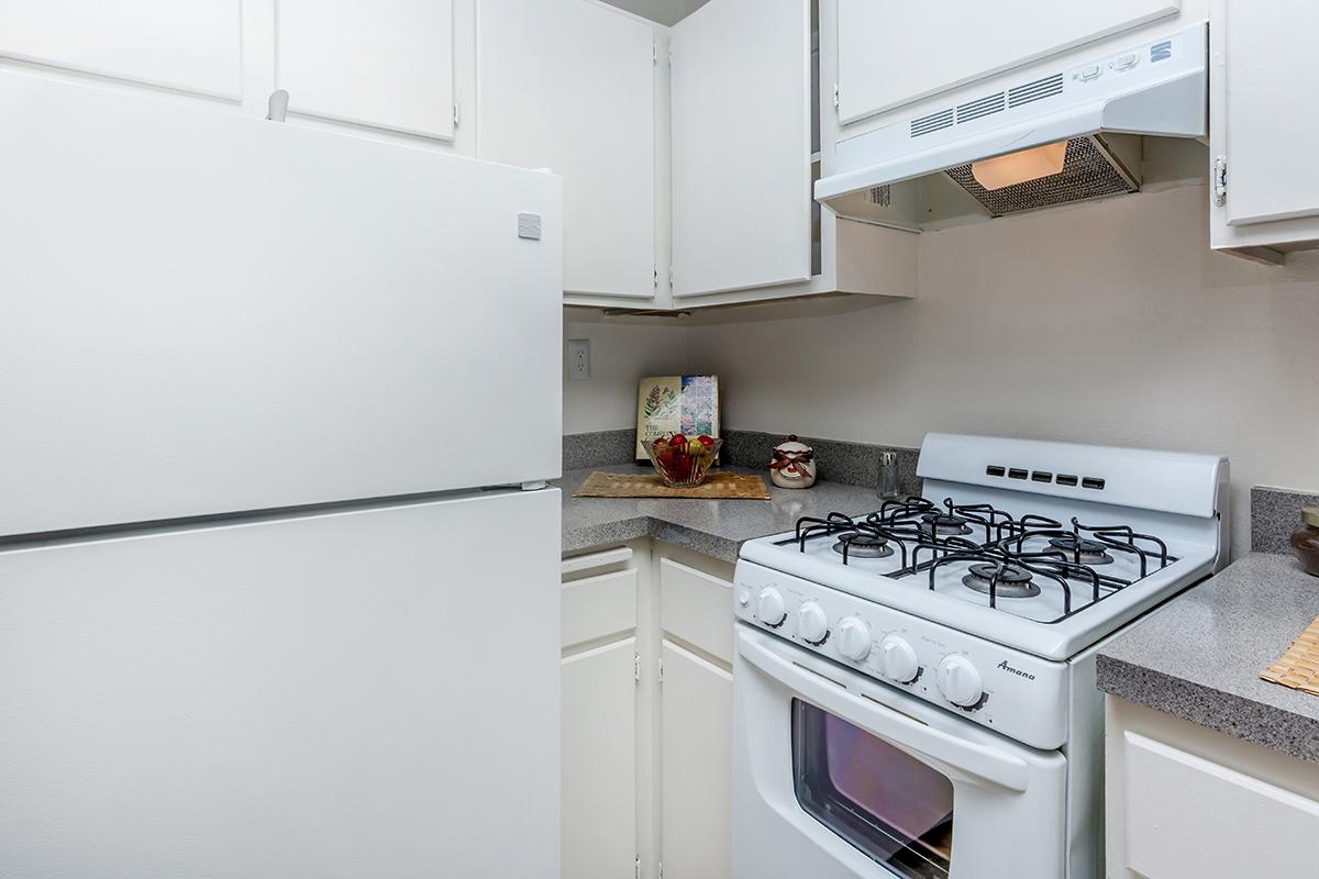 a kitchen with a white stove top oven sitting inside of a refrigerator