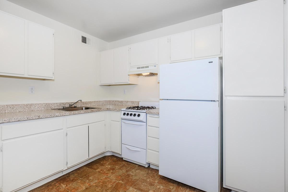 a white refrigerator freezer sitting inside of a kitchen