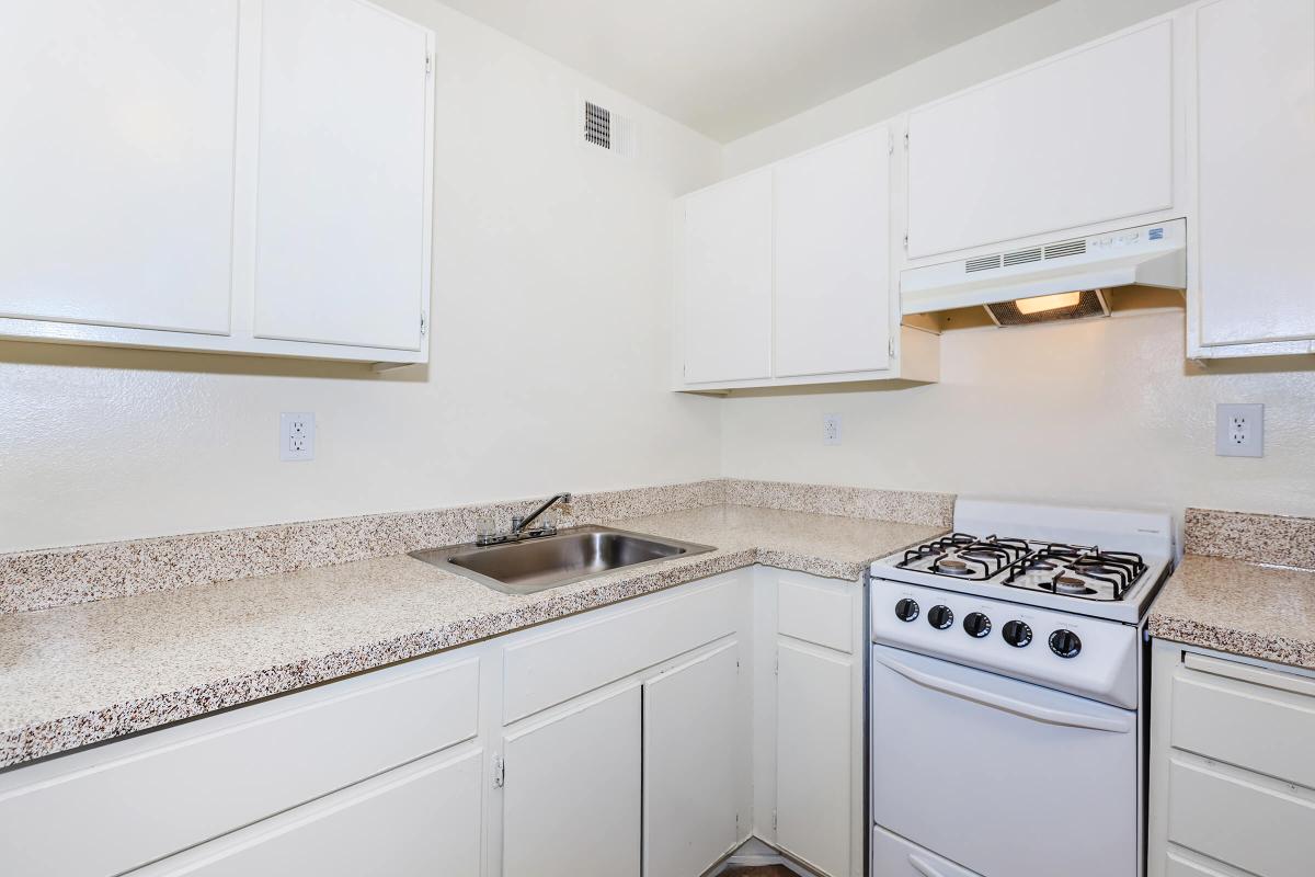 a kitchen with a stove a sink and a microwave