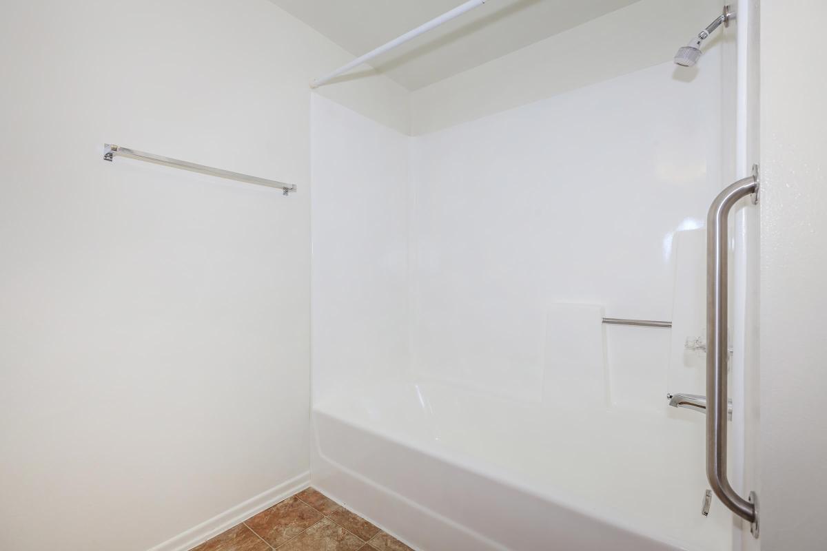 a white tub sitting next to a shower