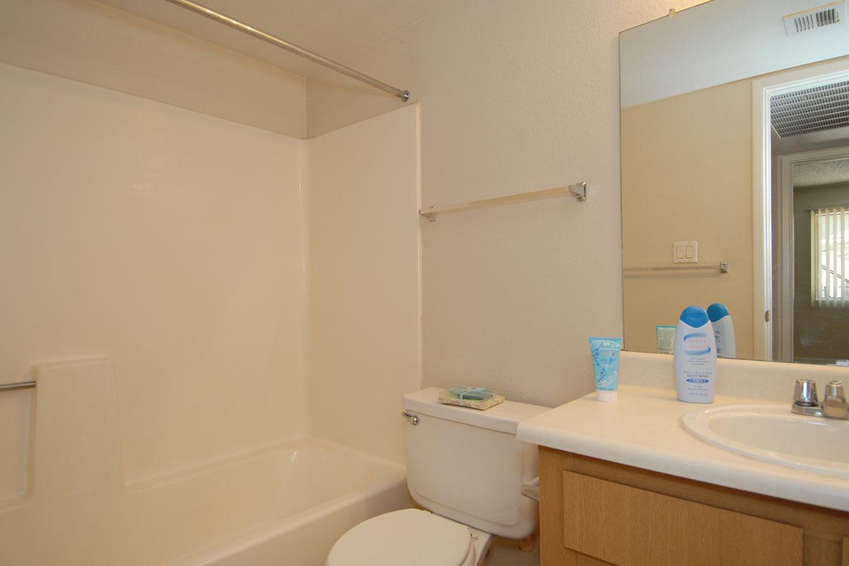 a white tub sitting next to a sink