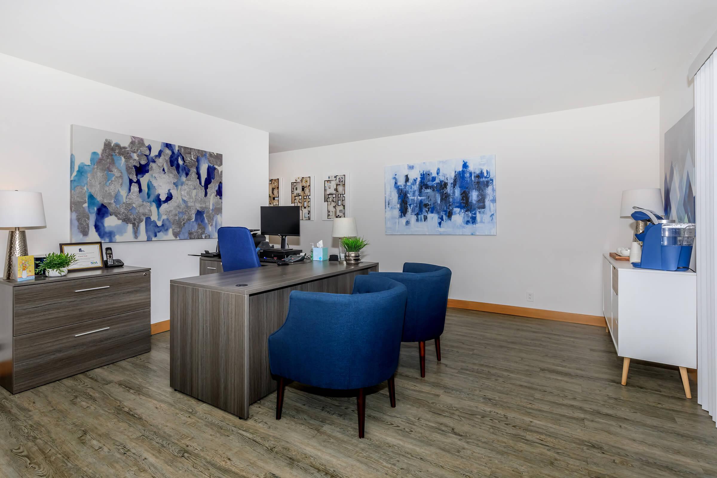 a living room filled with furniture and a blue chair