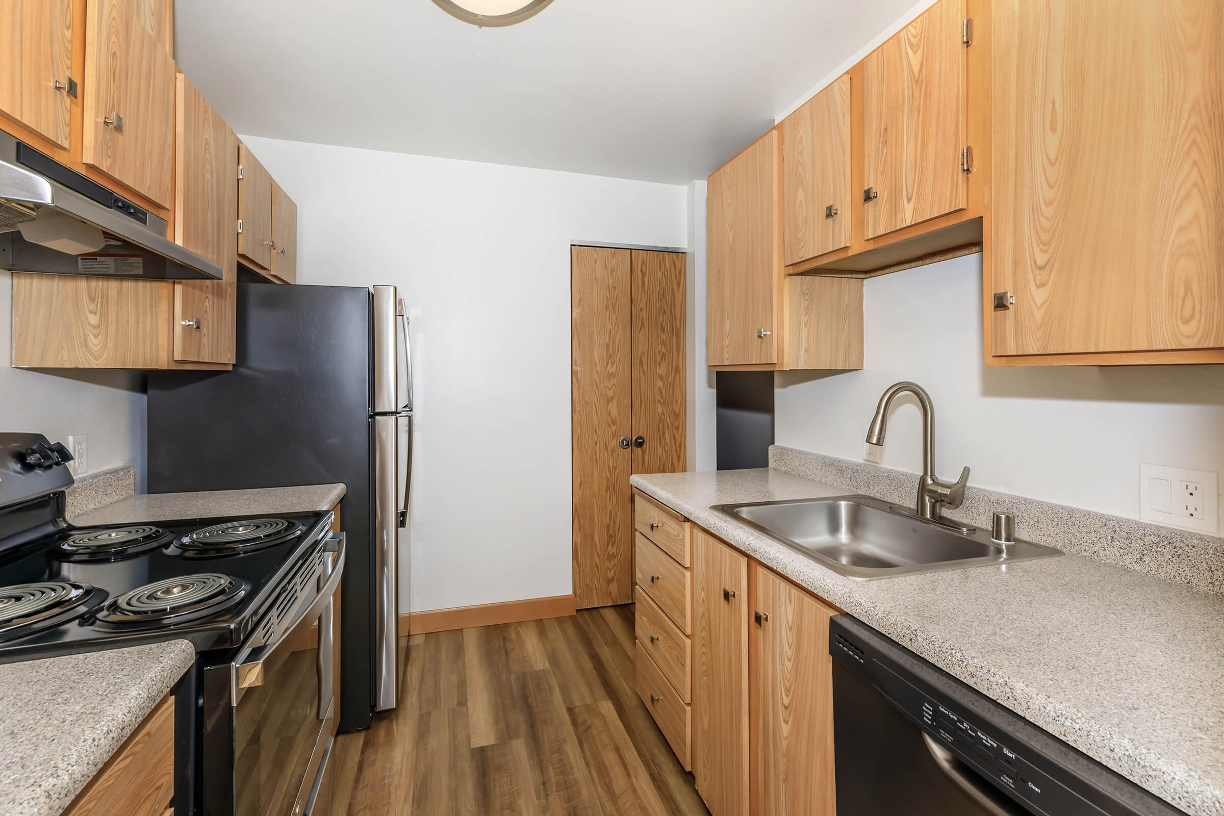 a kitchen with stainless steel appliances and wooden cabinets