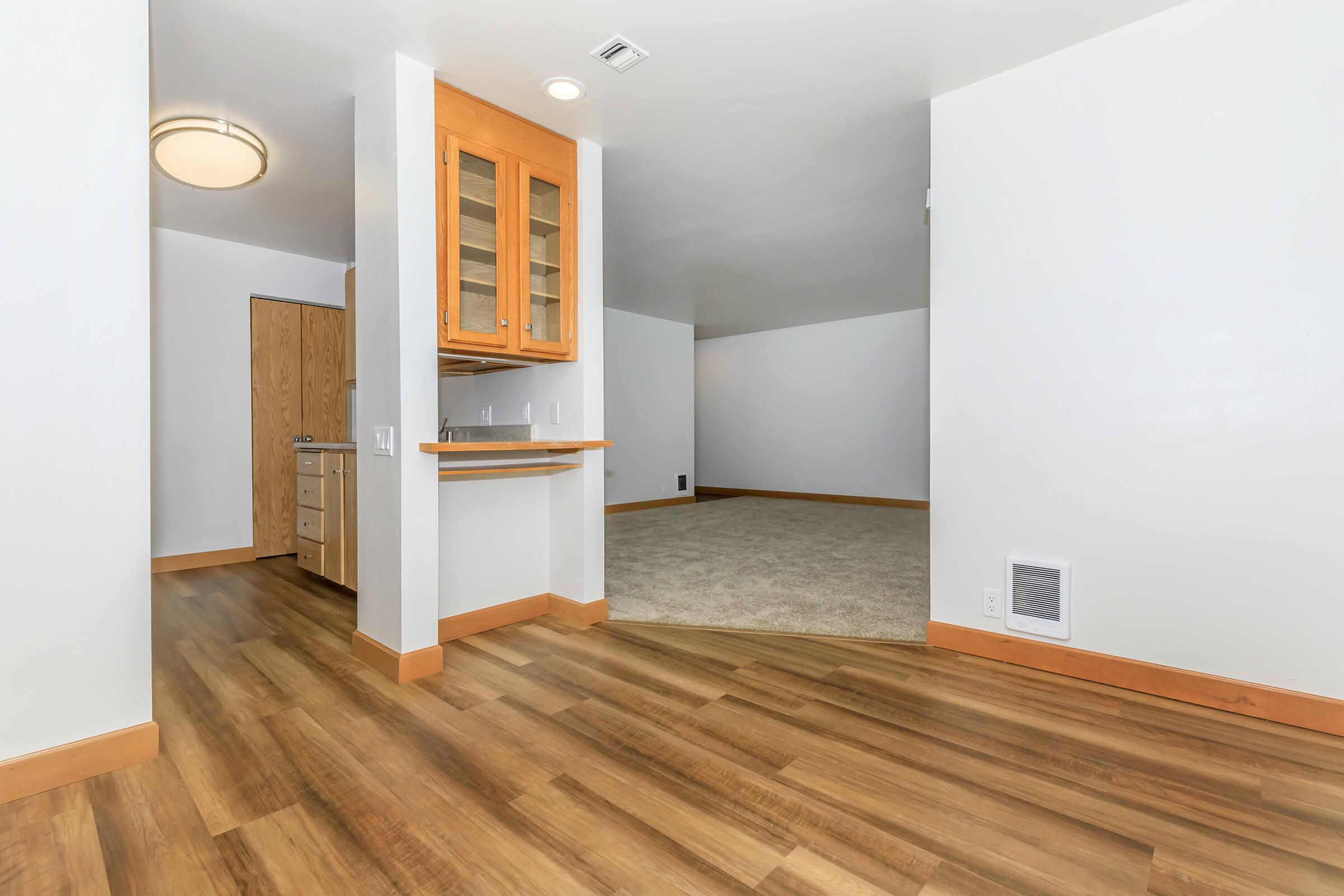 a large empty room with a wood floor