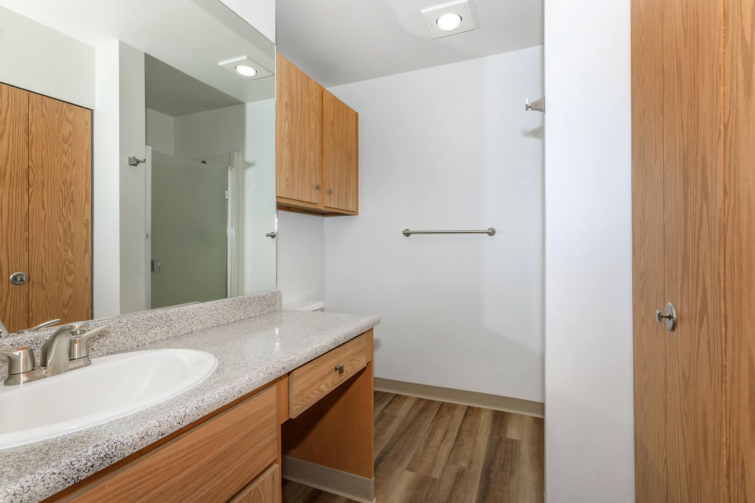 a kitchen with a sink and a mirror